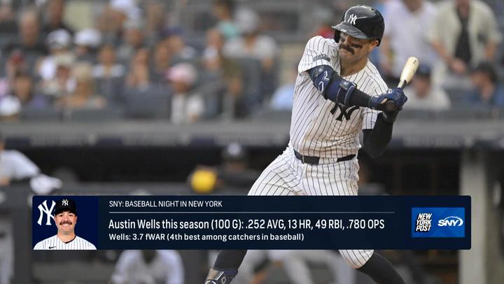 Austin Wells, pivotal for Yankees in 2024, batting during a game. 13 HR, 49 RBI, .252 AVG, 100 games.