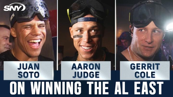 New York Yankees stars Aaron Judge, Juan Soto, and Gerrit Cole celebrate winning the AL East.