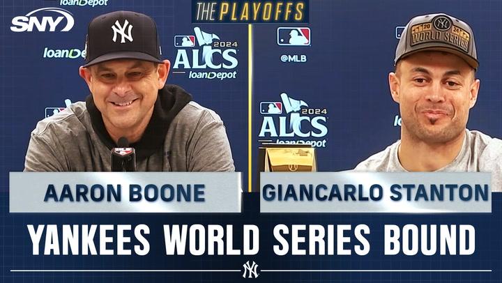 Aaron Boone and Giancarlo Stanton celebrate Yankees' World Series return after ALCS win.