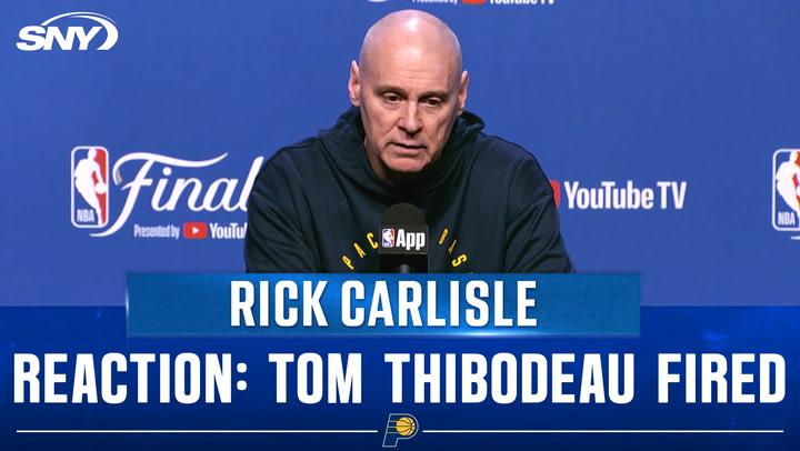 Rick Carlisle at a podium.