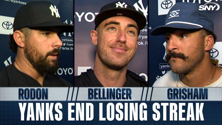 Three Yankees players smiling.