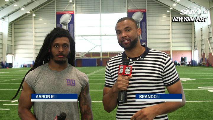 Brandon London talks with Giants cornerback Aaron Robinson