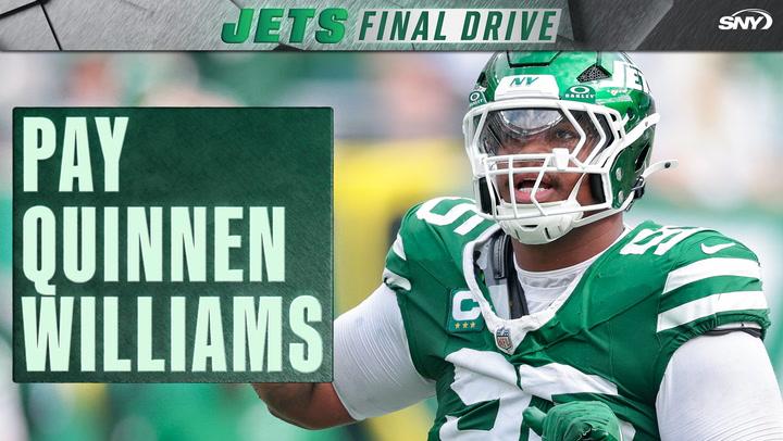Jets player with "Pay Quinnen" sign.
