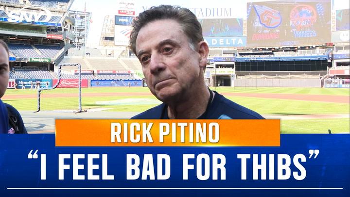 Man speaking at baseball stadium.