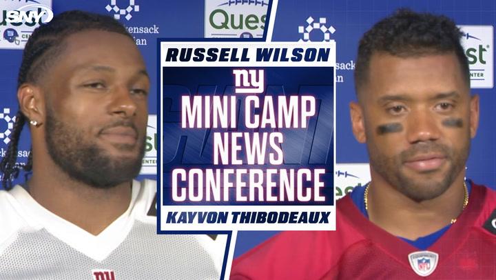 NFL players at press event.