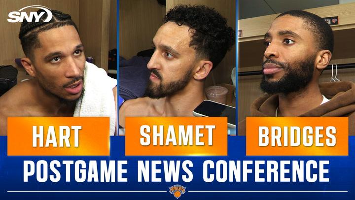 Three players at press conference.