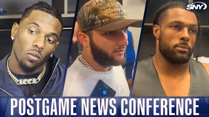 Three athletes at press conference.