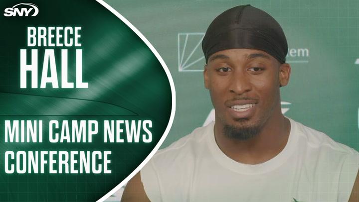 Football player at press podium.