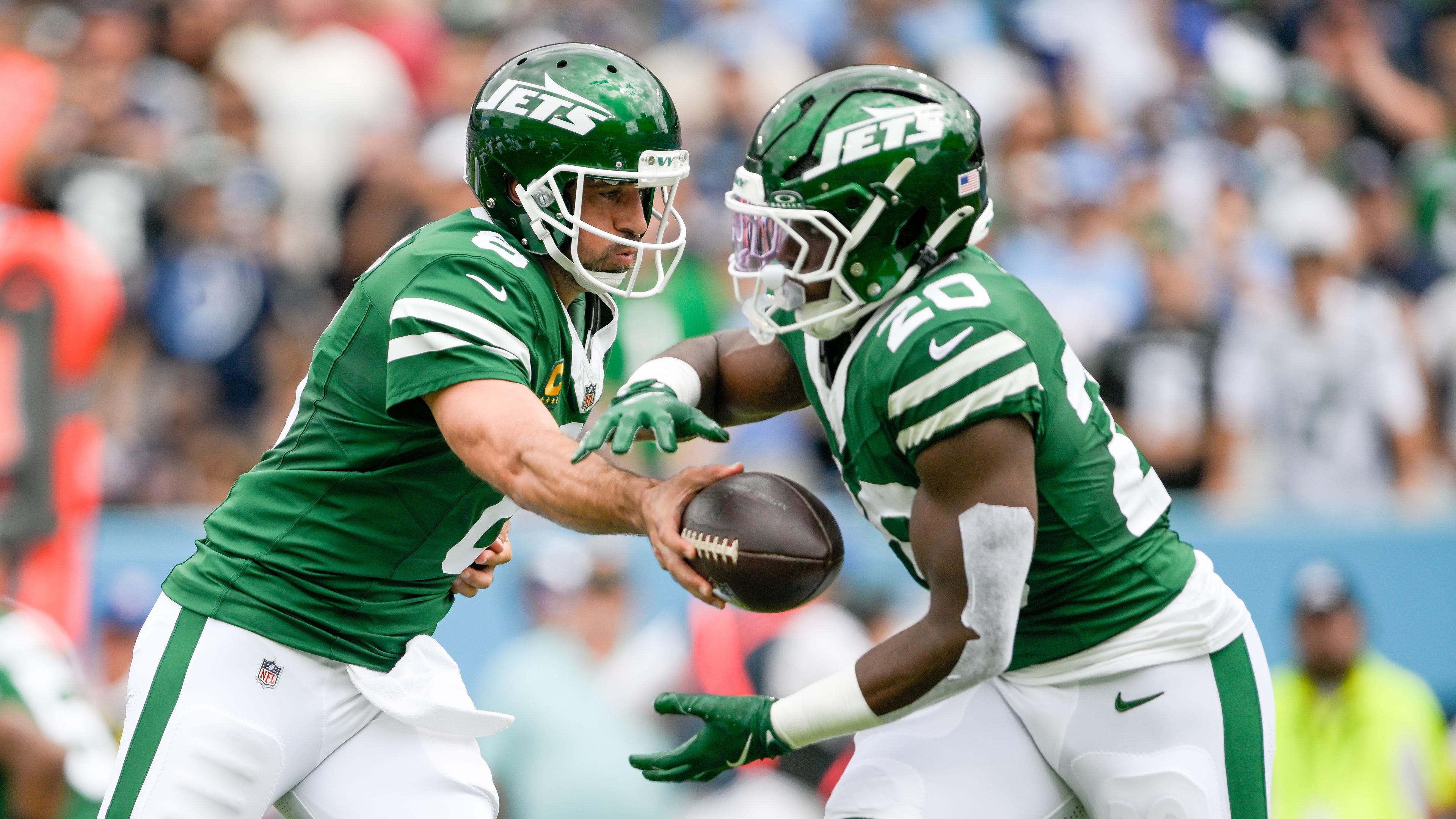 Sep 15, 2024; Nashville, Tennessee, USA; New York Jets quarterback Aaron Rodgers (8) hands the ball to running back Breece Hall (20) against the Tennessee Titans during the first half at Nissan Stadium. Mandatory Credit: Steve Roberts-Imagn Images