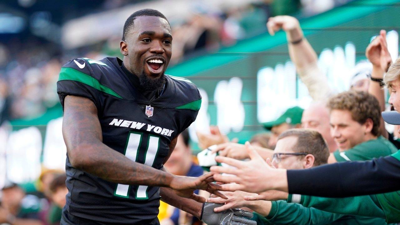 New York Jets wide receiver Denzel Mims celebrates with fans after the game