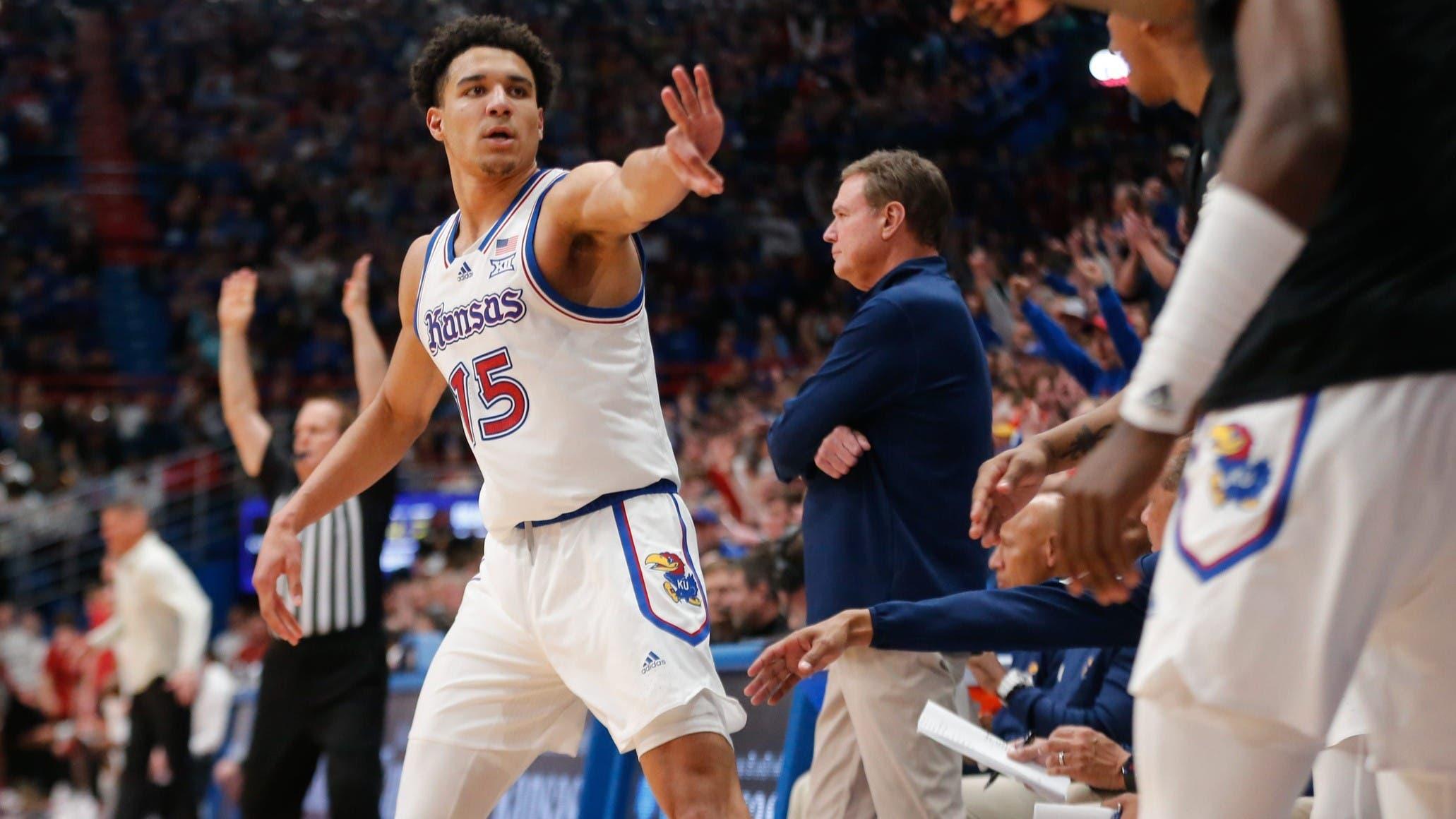 Kansas graduate senior guard Kevin McCullar Jr. (15) looks back at his bench after sinking a three against Oklahoma in the second half of the game Saturday, Jan. 13, 2024, inside Allen Fieldhouse. / Evert Nelson/The Capital-Journal / USA TODAY NETWORK