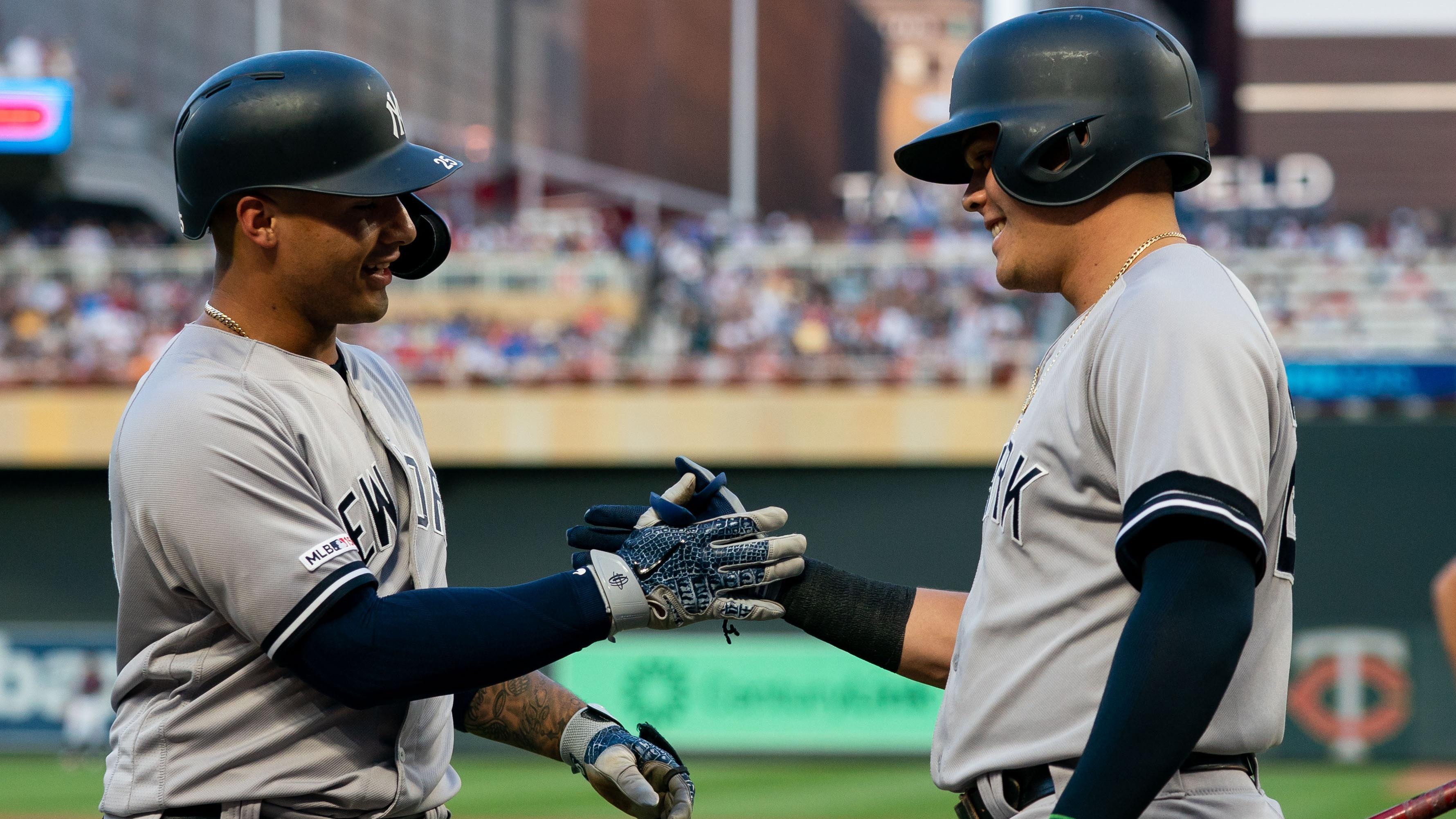 Jul 24, 2019; Minneapolis, MN, USA; New York Yankees second baseman Gleyber Torres (25) celebrates after hitting a home run with third baseman Gio Urshela (right) in the third inning against Minnesota Twins at Target Field. Mandatory Credit: Brad Rempel-USA TODAY Sports