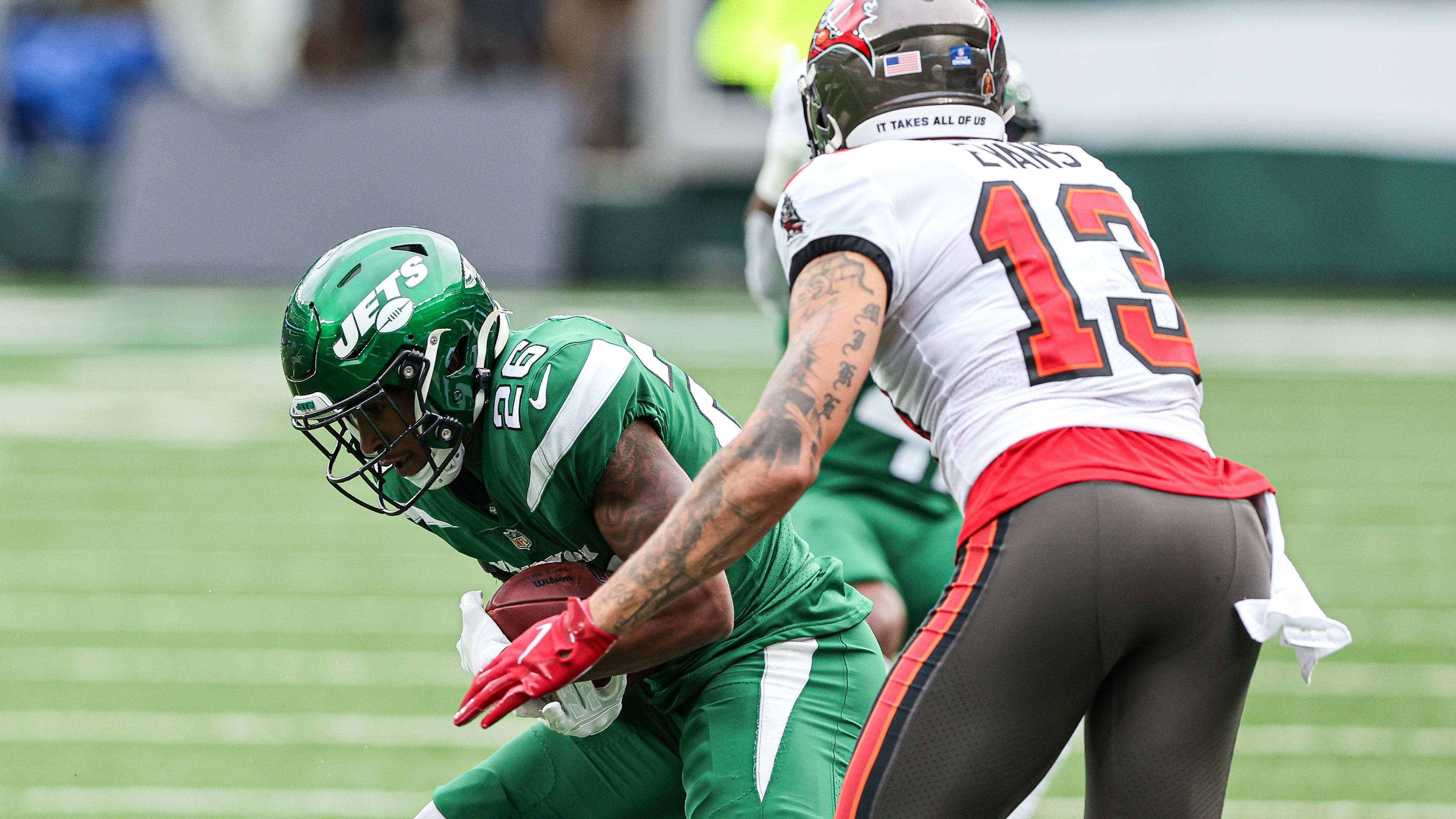 Jan 2, 2022; East Rutherford, New Jersey, USA; New York Jets cornerback Brandin Echols (26) intercepts a pass intended for Tampa Bay Buccaneers wide receiver Mike Evans (13) during the first half at MetLife Stadium.