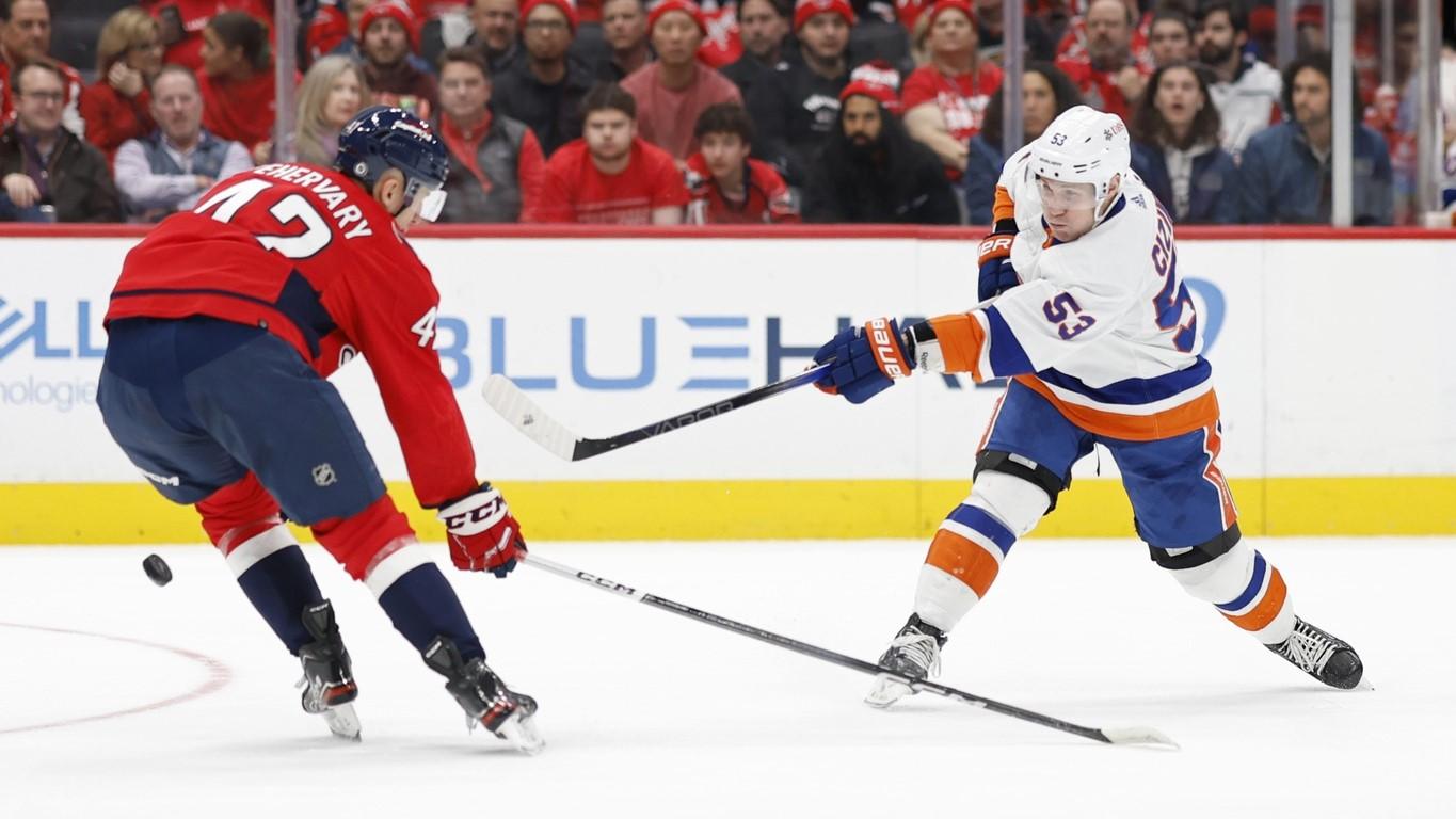 Dec 20, 2023; Washington, District of Columbia, USA; New York Islanders center Casey Cizikas (53) shoots the puck as Washington Capitals defenseman Martin Fehervary (42) defends in the second period at Capital One Arena.