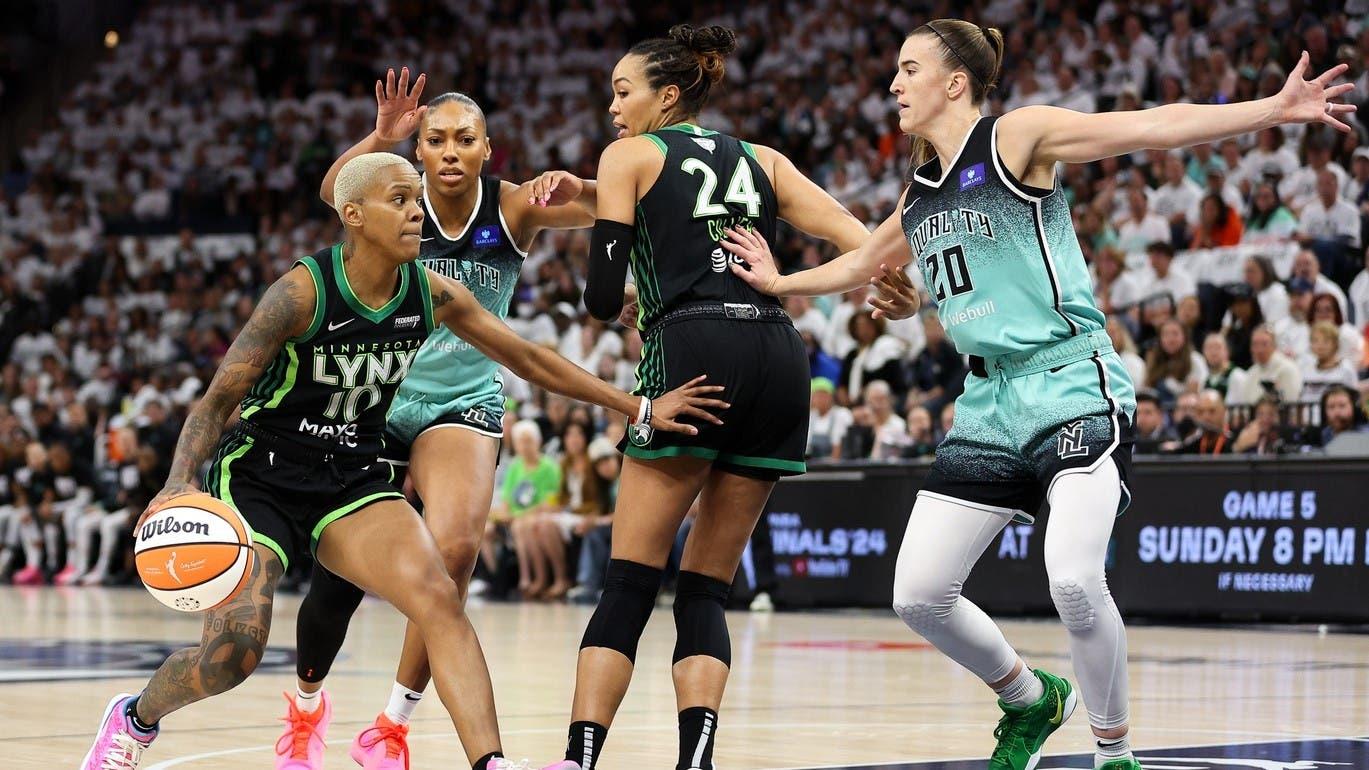 Oct 18, 2024; Minneapolis, Minnesota, USA; Minnesota Lynx guard Courtney Williams (10) drives toward the basket as New York Liberty forward Betnijah Laney-Hamilton (44) and guard Sabrina Ionescu (20) defend during the first half of game four of the 2024 WNBA Finals at Target Center. / Matt Krohn-Imagn Images