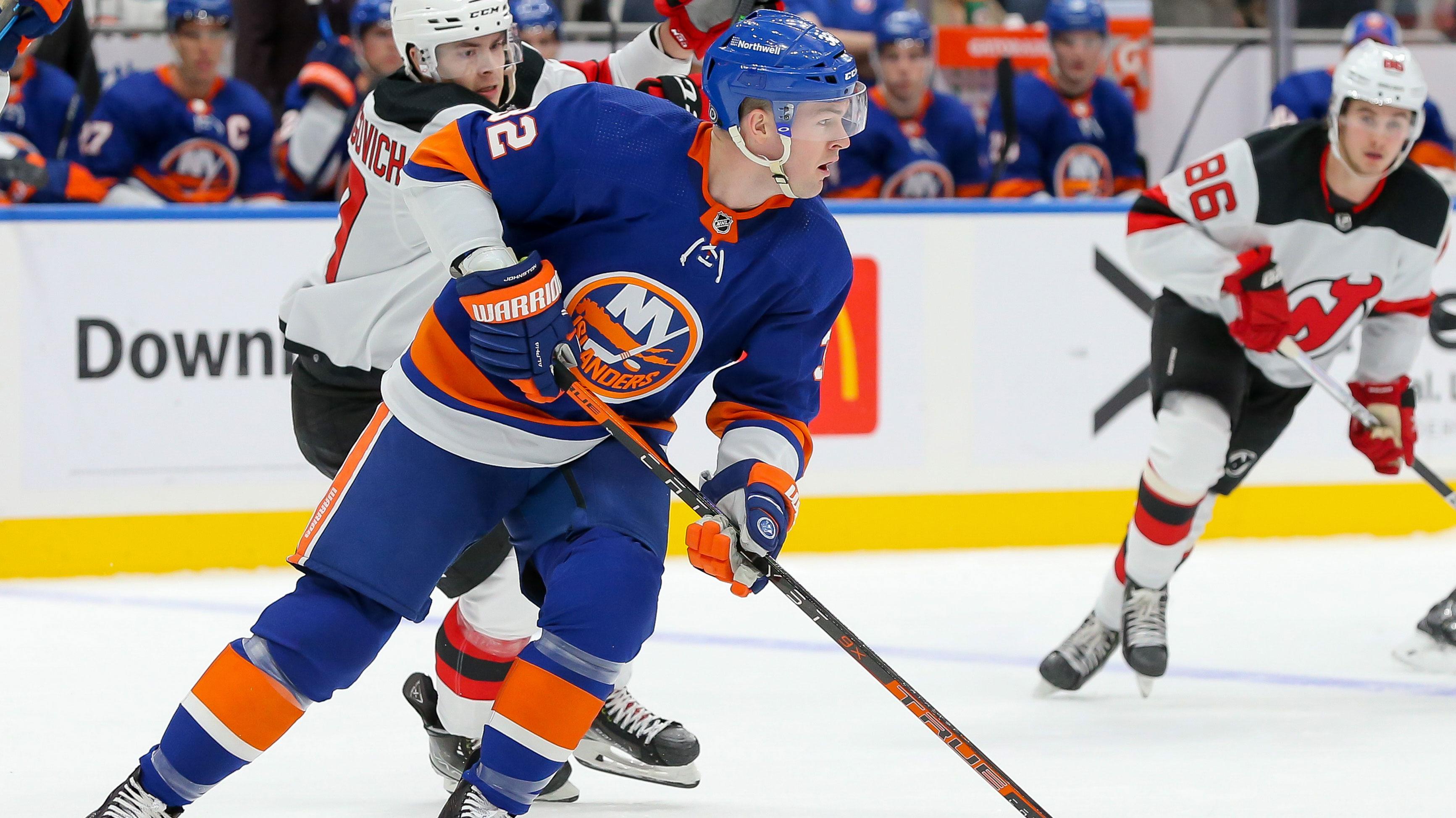 Dec 11, 2021; Elmont, New York, USA; New York Islanders left wing Ross Johnston (32) skates with the puck against New Jersey Devils during the first period at UBS Arena.