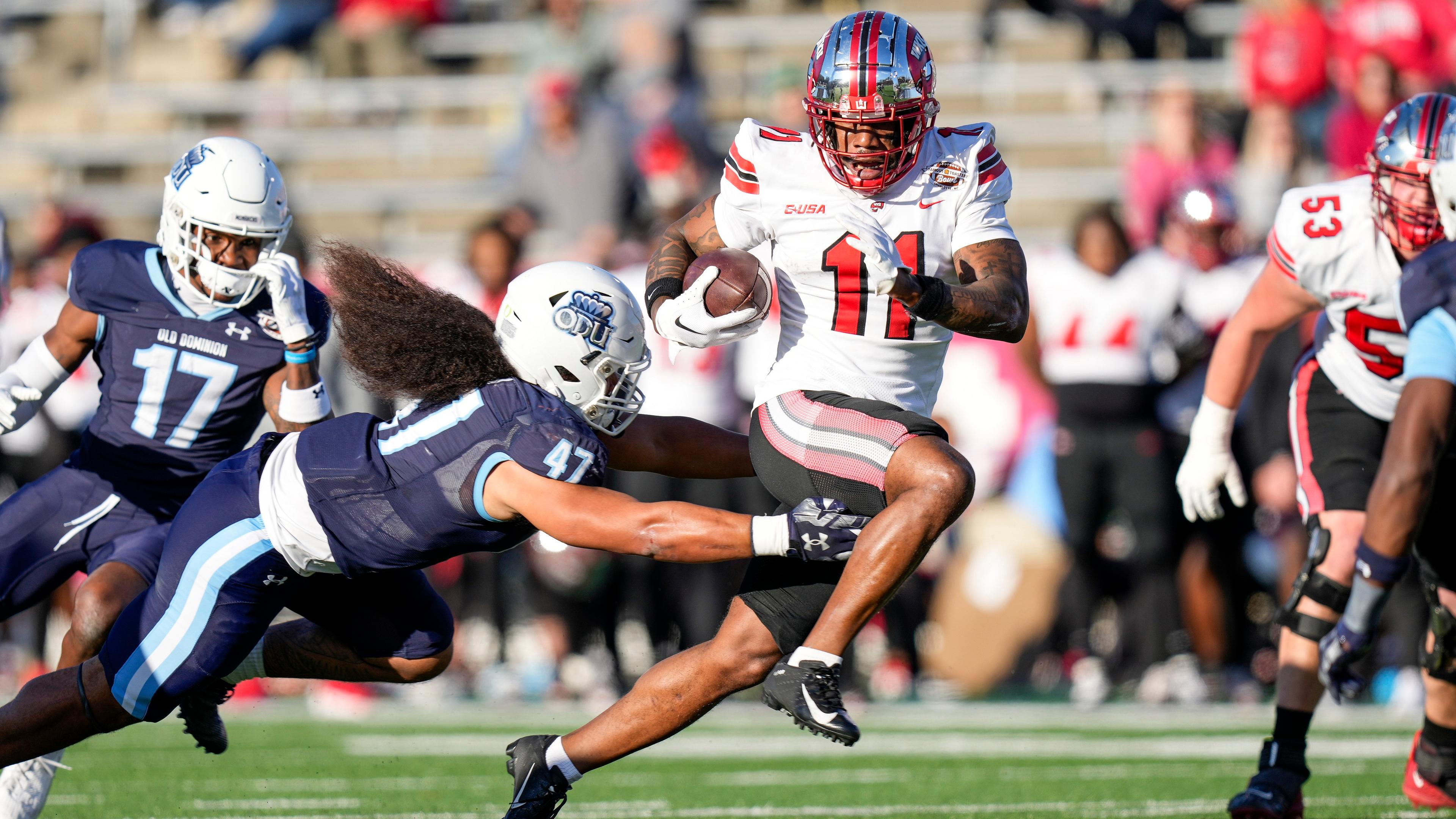 Western Kentucky Hilltoppers wide receiver Malachi Corley (11) runs the ball against Old Dominion Monarchs linebacker Koa Naotala (47) during the first quarter at Charlotte 49ers' Jerry Richardson Stadium. 