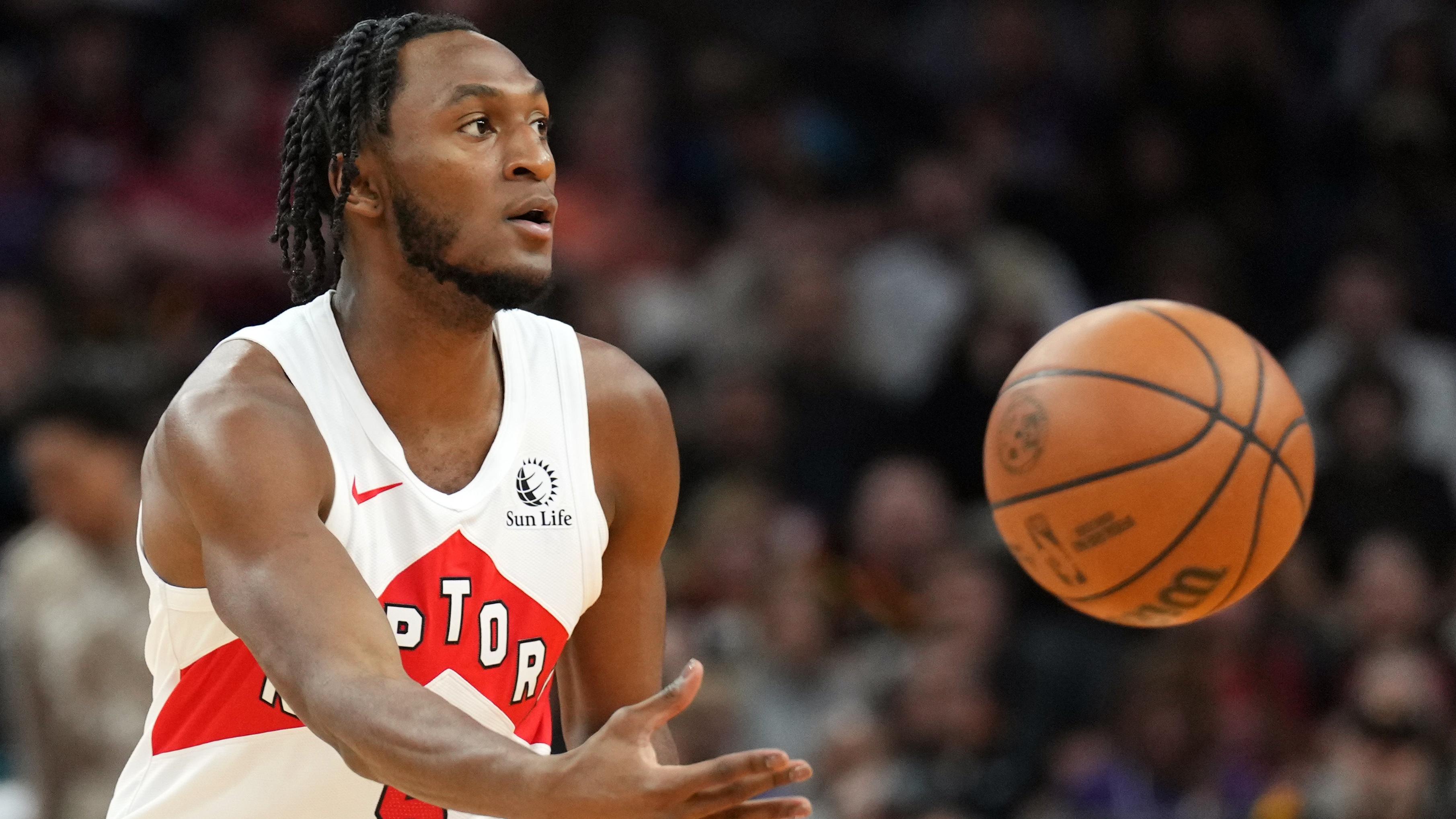 Toronto Raptors guard Immanuel Quickley (5) passes against the Phoenix Suns during the first half at Footprint Center. 