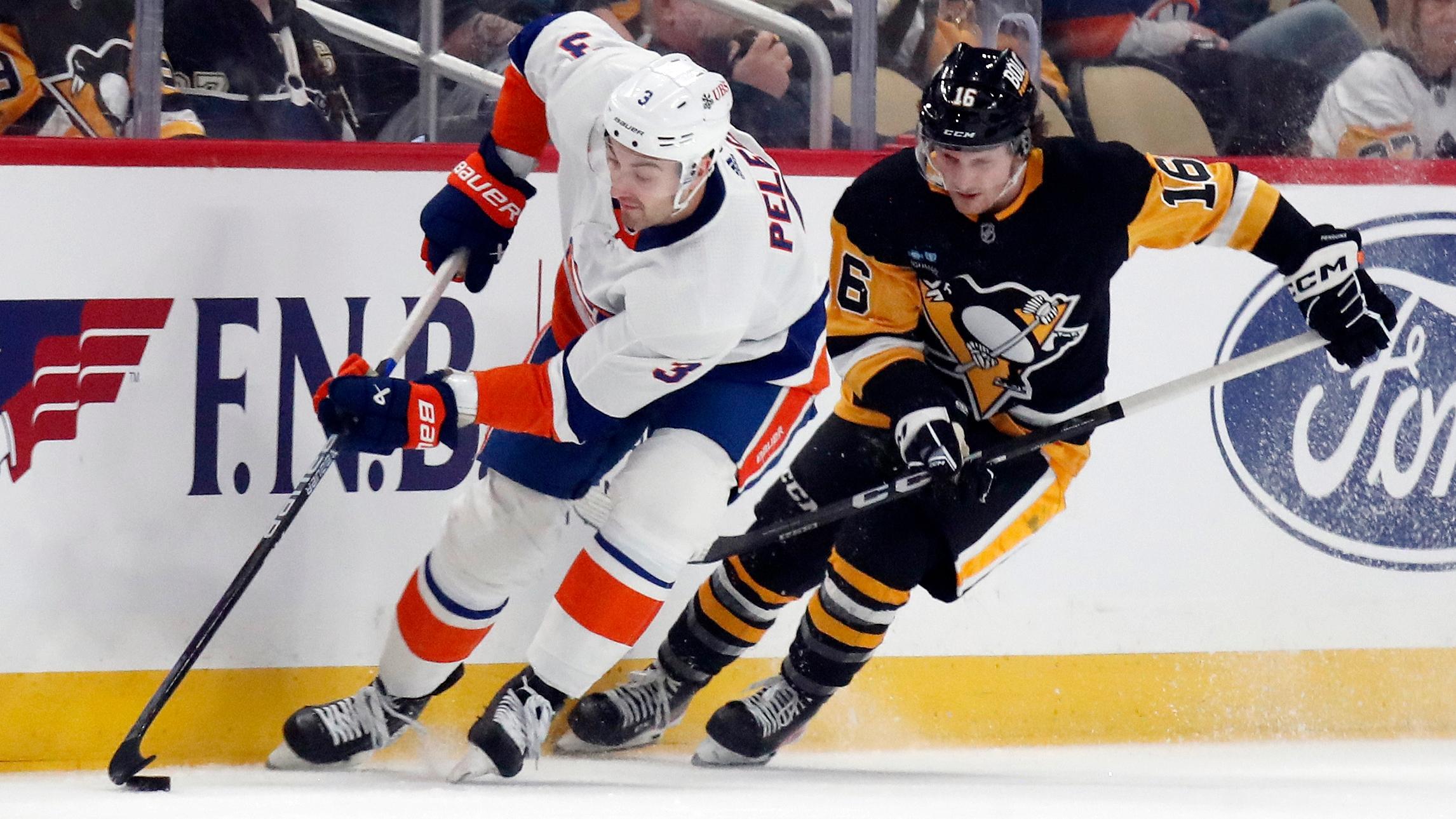 New York Islanders defenseman Adam Pelech (3) moves the puck against Pittsburgh Penguins right wing Matthew Phillips (16) during the first period at PPG Paints Arena.