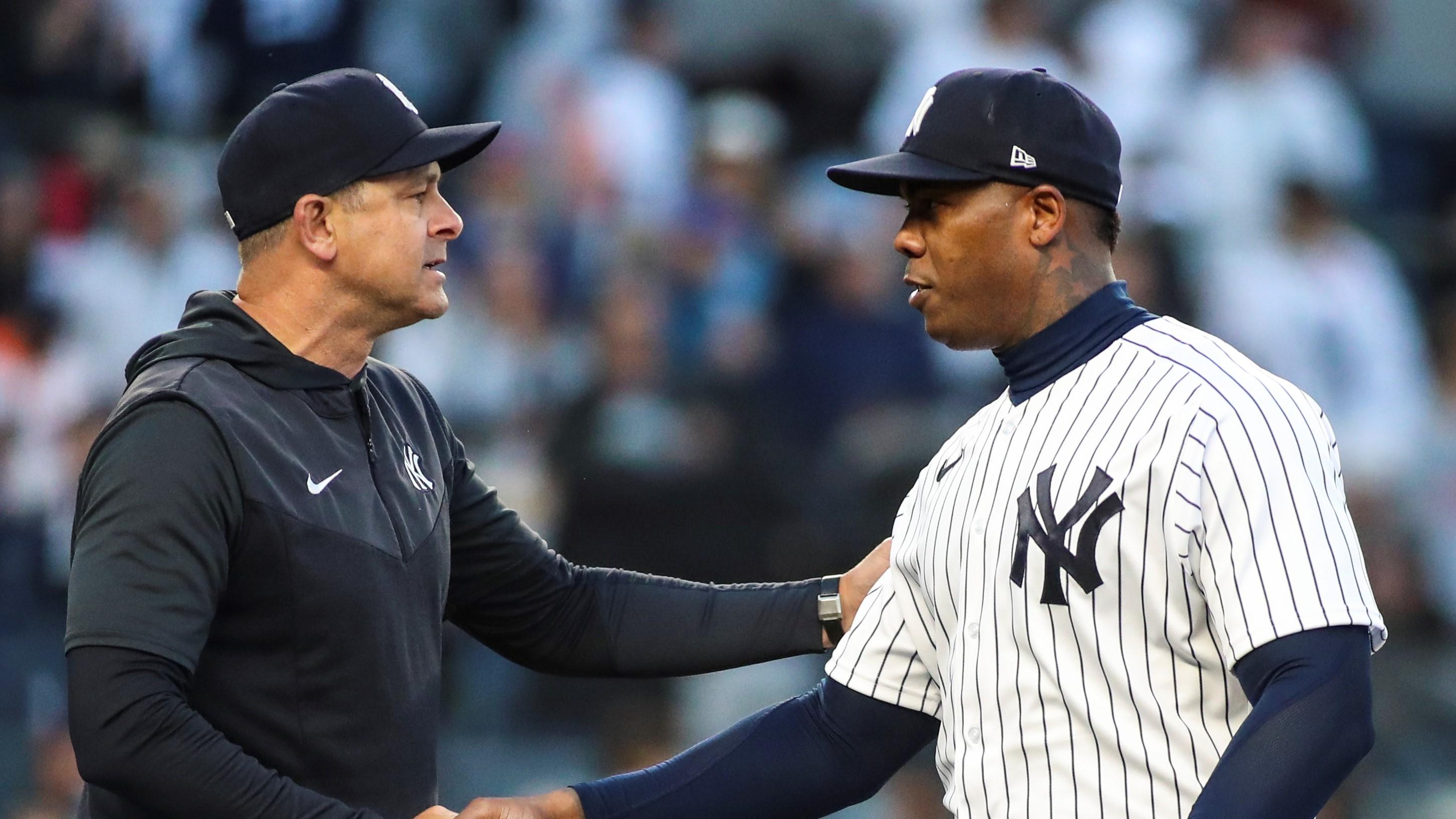 New York Yankees manager Aaron Boone (17) congratulates relief pitcher Aroldis Chapman (54) after recording a save in the 4-2 victory over the Boston Red Sox at Yankee Stadium.