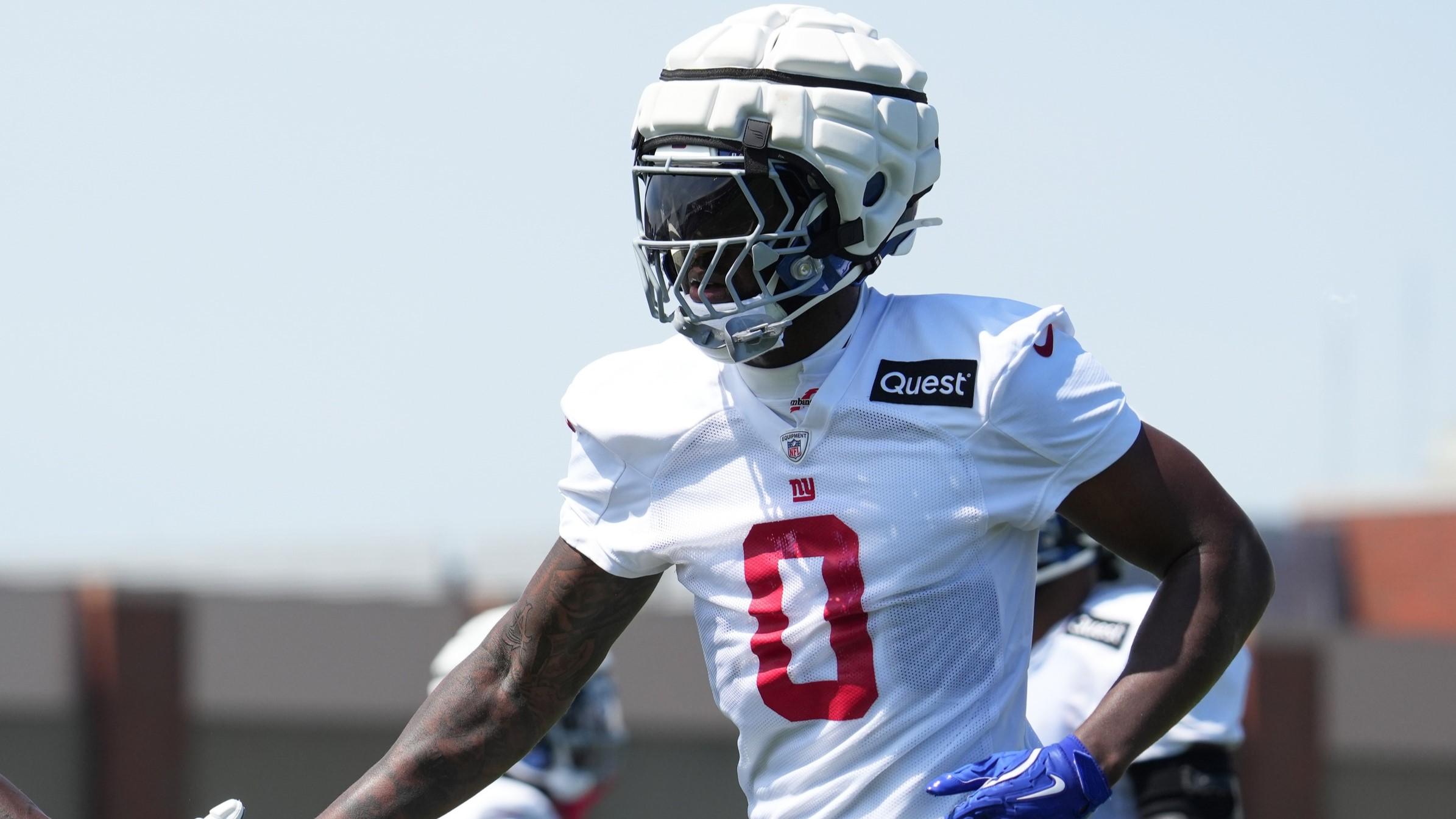 Jul 26, 2024; East Rutherford, NJ, USA; New York Giants linebacker Brian Burns (0) high fives New York Giants defensive tackle Rakeem Nunez-Roches (93) during training camp at Quest Diagnostics Training Center.