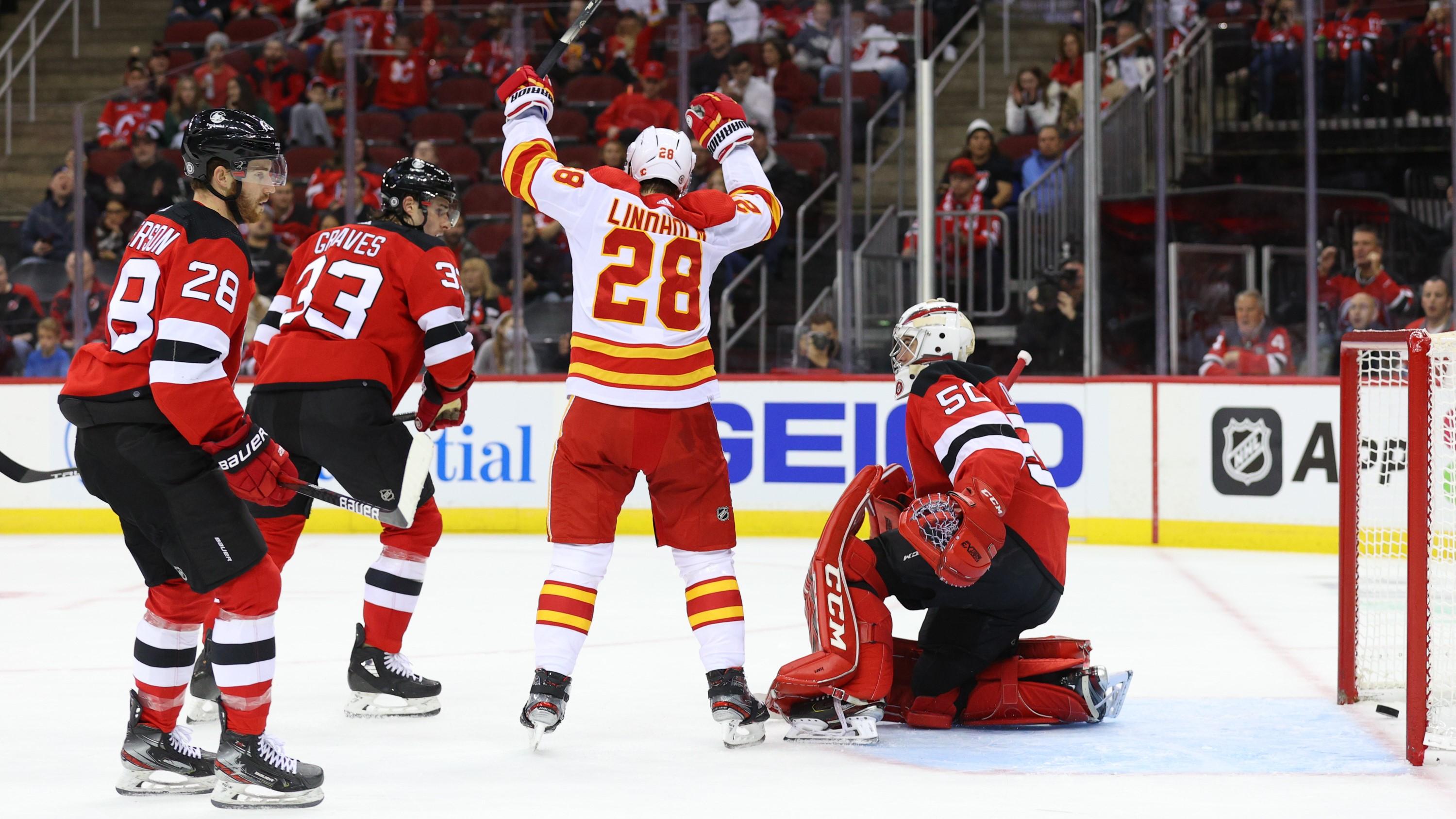 Oct 26, 2021; Newark, New Jersey, USA; Calgary Flames center Elias Lindholm (28) celebrates his goal on New Jersey Devils goaltender Nico Daws (50) during the first period at Prudential Center. Mandatory Credit: Ed Mulholland-USA TODAY Sports