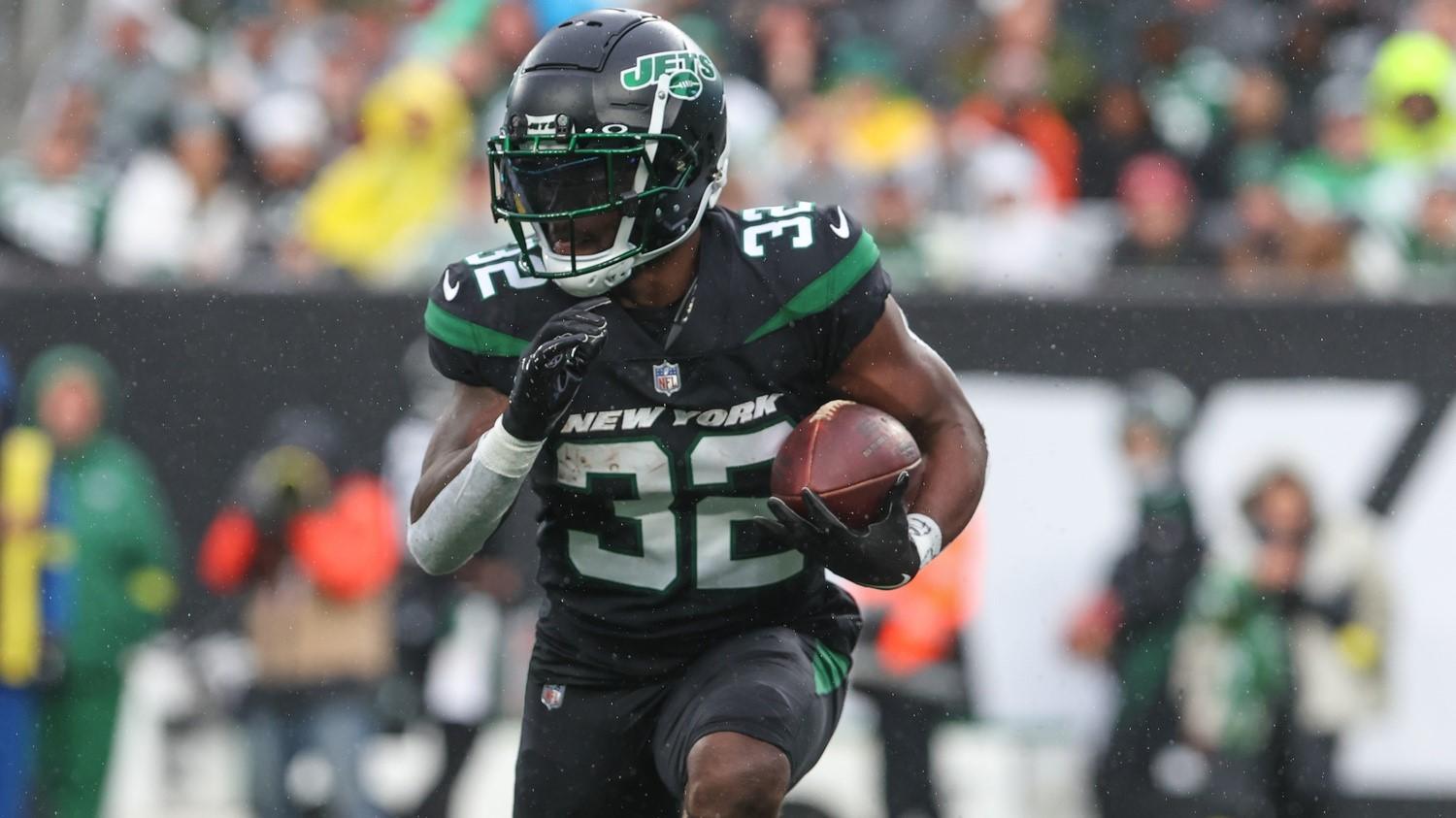 Nov 27, 2022; East Rutherford, New Jersey, USA; New York Jets running back Michael Carter (32) runs with the ball against the Chicago Bears during the first half at MetLife Stadium.