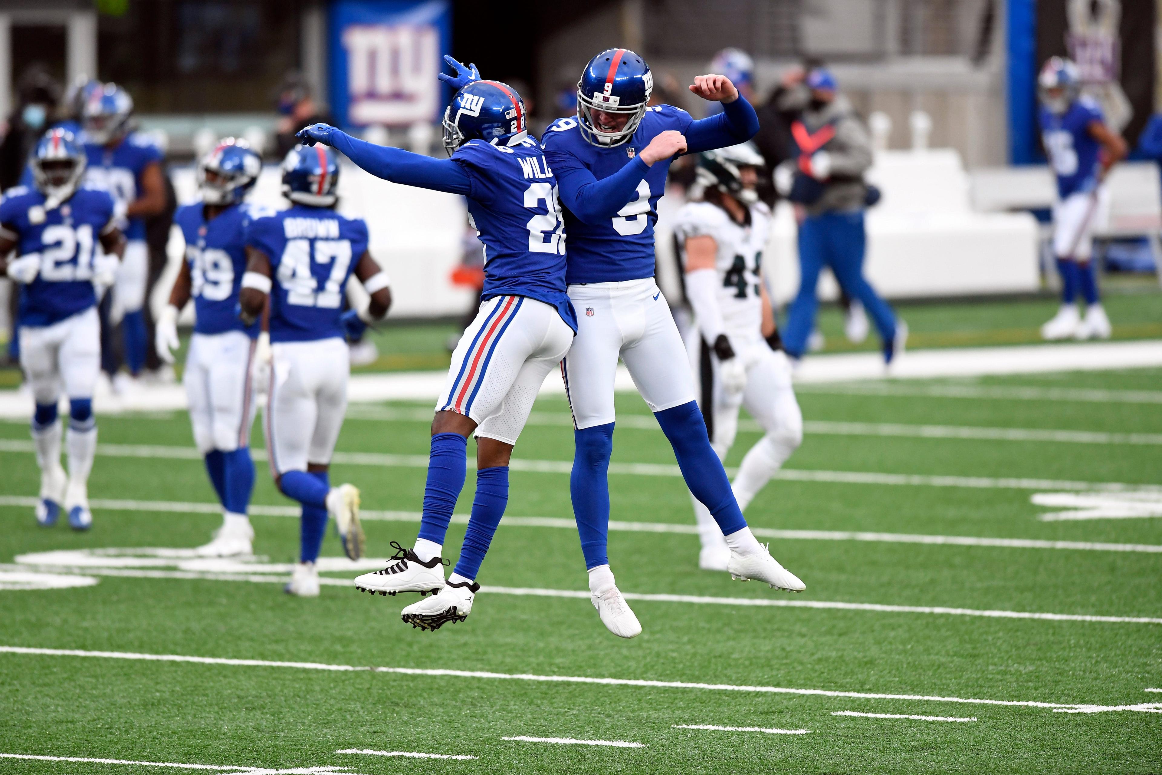 New York Giants cornerback Brandon Williams (28) and punter Riley Dixon (9) react after Dixon's punt lands at the Eagles' six yard line in the first half of a game at MetLife Stadium on Sunday, Nov. 15, 2020