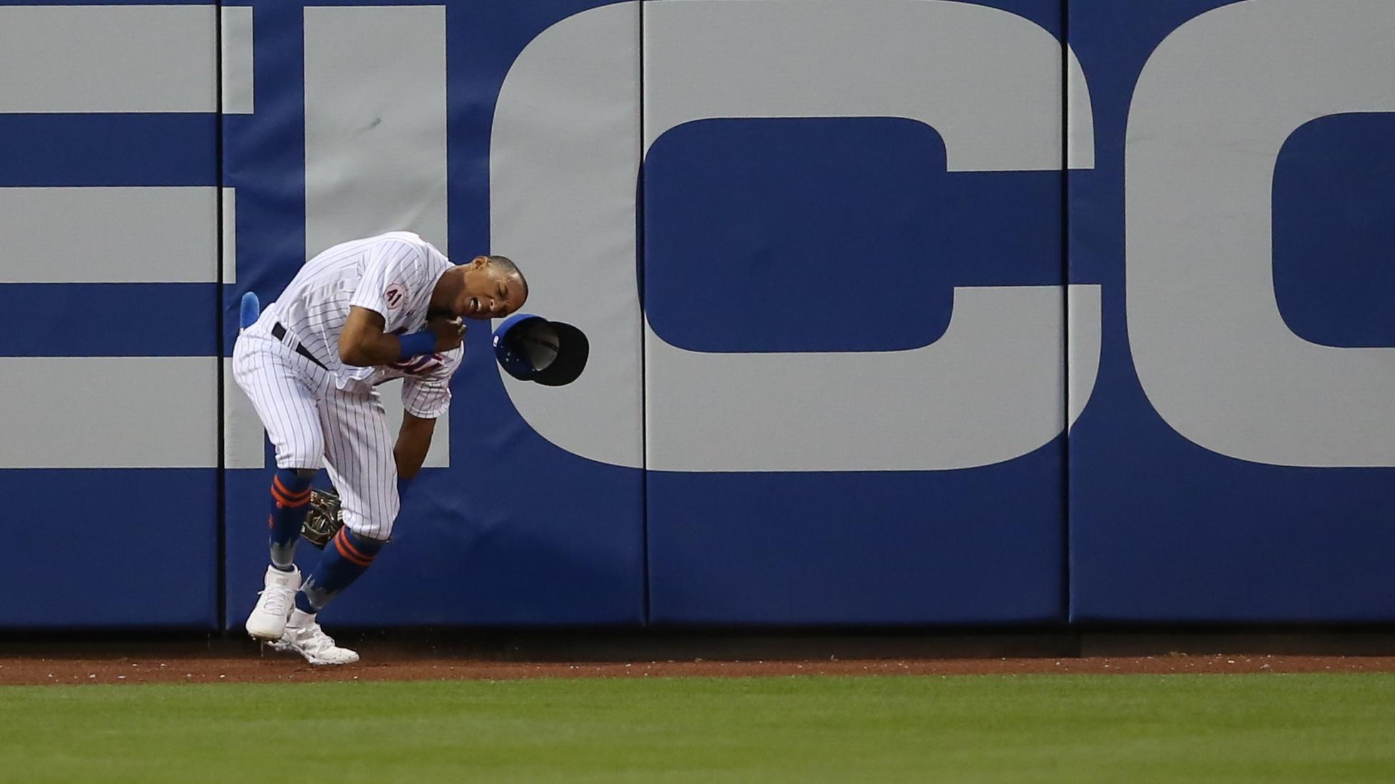 May 24, 2021; New York City, New York, USA; New York Mets center fielder Johneshwy Fargas (81) reacts after crashing into the wall while trying to catch an RBI triple by Colorado Rockies center fielder Garrett Hampson (not pictured) during the fourth inning at Citi Field