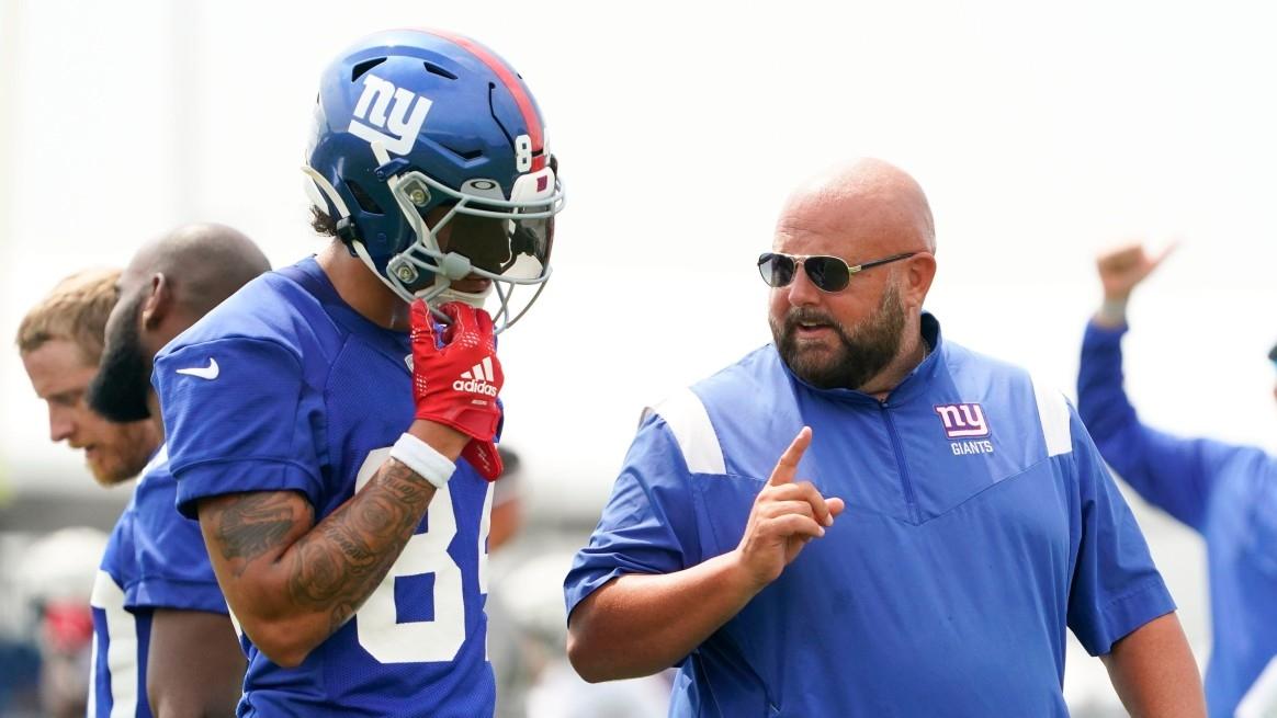 New York Giants rookie wide receiver Jalin Hyatt, left, and head coach Brian Daboll talk during training camp.