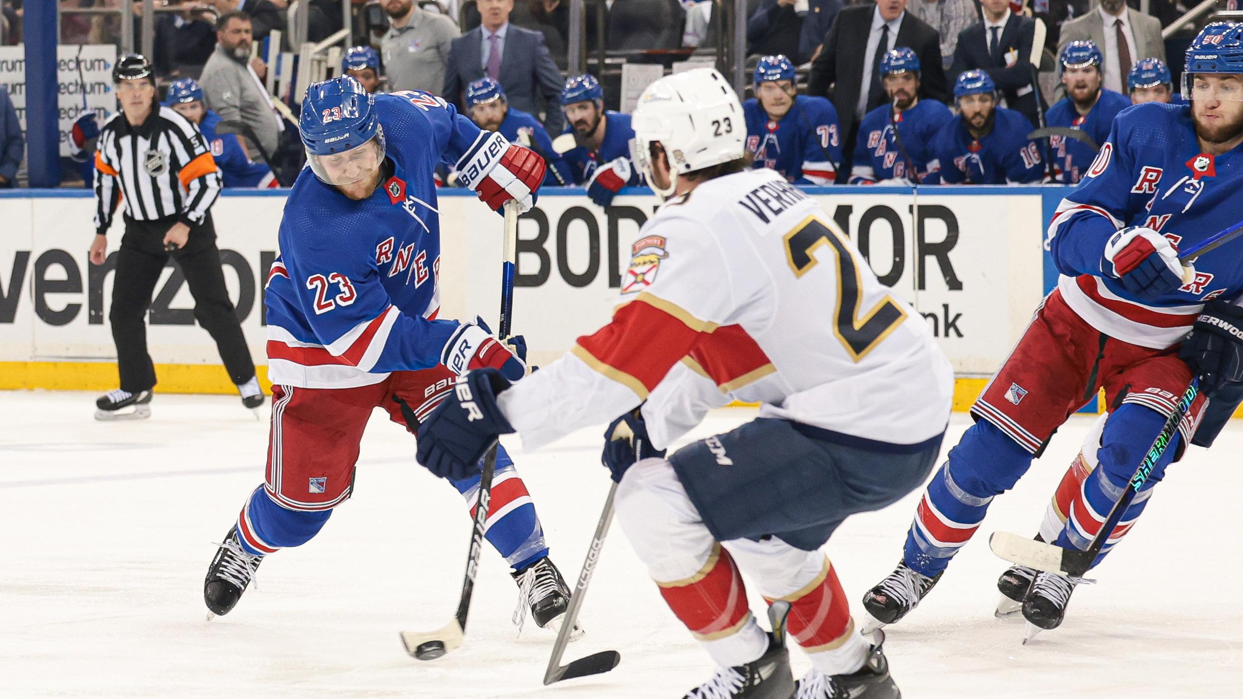 New York Rangers defenseman Adam Fox (23) shoots the puck as Florida Panthers center Carter Verhaeghe (23) defends during the second period in game two of the Eastern Conference Final of the 2024 Stanley Cup Playoffs at Madison Square Garden. 