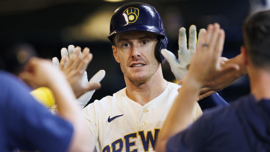 Aug 22, 2023; Milwaukee, Wisconsin, USA; Milwaukee Brewers designated hitter Mark Canha (21) high fives teammates in the dugout after scoring a run during the sixth inning against the Minnesota Twins at American Family Field. Mandatory Credit: Jeff Hanisch-USA TODAY Sports