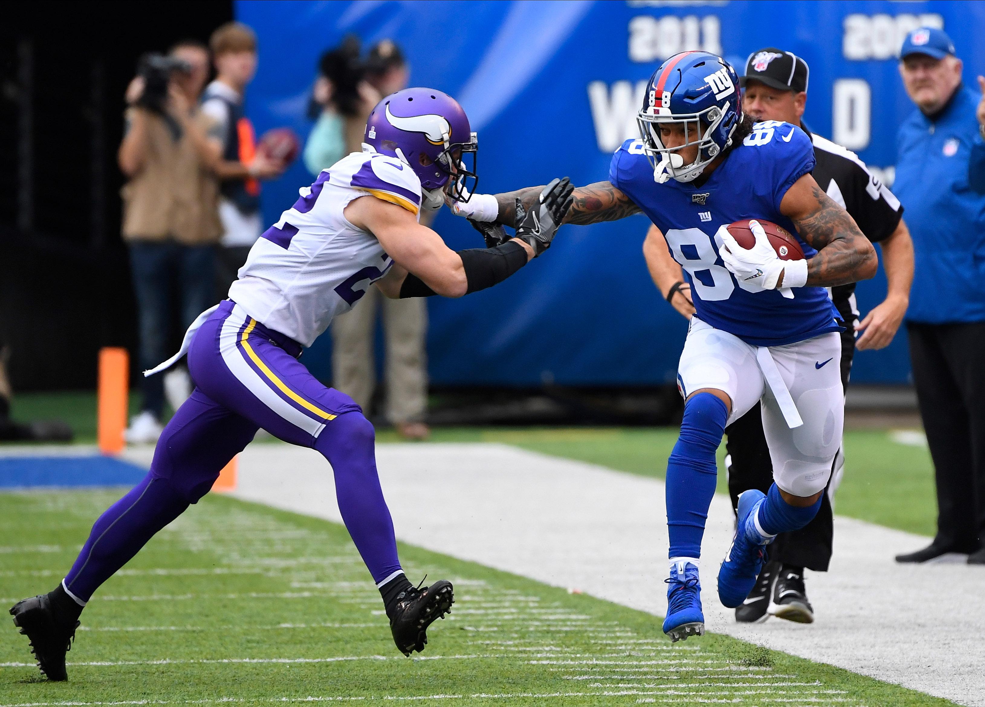 Oct 6, 2019; East Rutherford, NJ, USA; New York Giants tight end Evan Engram (88) gets a first down in the first quarter as Minnesota Vikings free safety Harrison Smith (22) defends at MetLife Stadium.