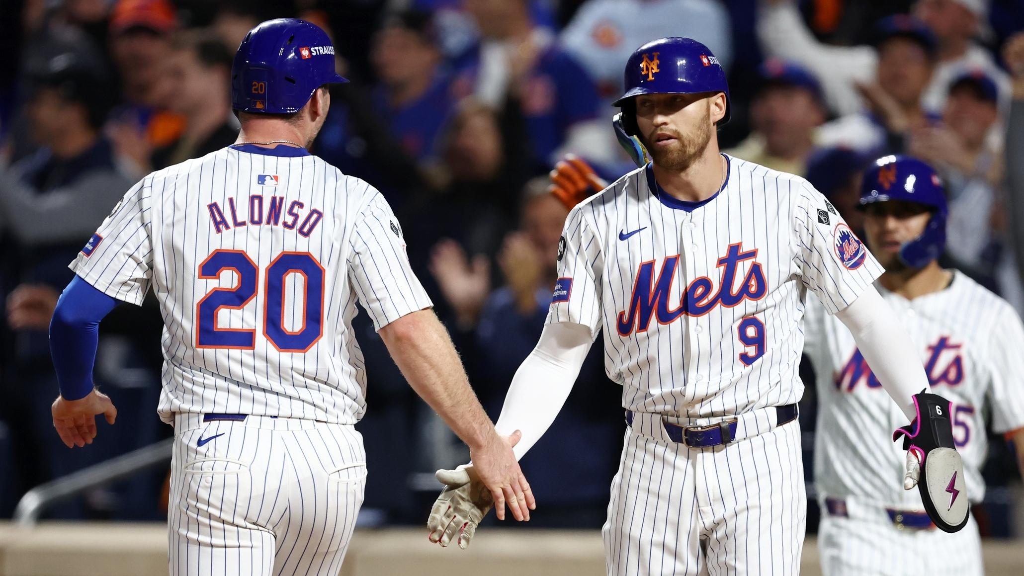 Oct 8, 2024; New York City, New York, USA; New York Mets first baseman Pete Alonso (20) celebrates scoring with outfielder Brandon Nimmo (9) on a two run single by outfielder Starling Marte (not pictured) in the sixth inning against the Philadelphia Phillies during game three of the NLDS for the 2024 MLB Playoffs at Citi Field.