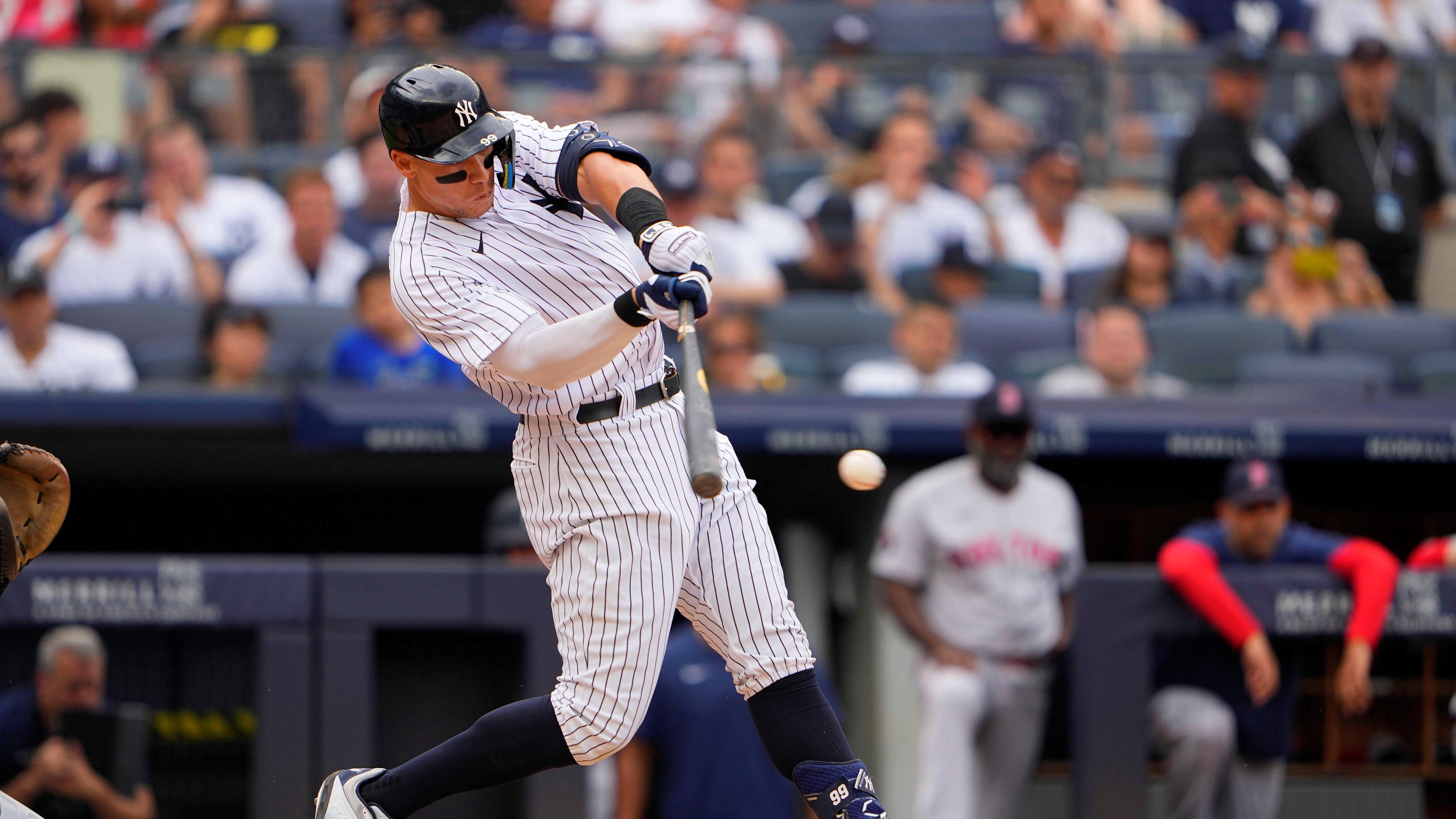 New York Yankees center fielder Aaron Judge (99) hits an RBI single against the Boston Red Sox during the fourth inning at Yankee Stadium.