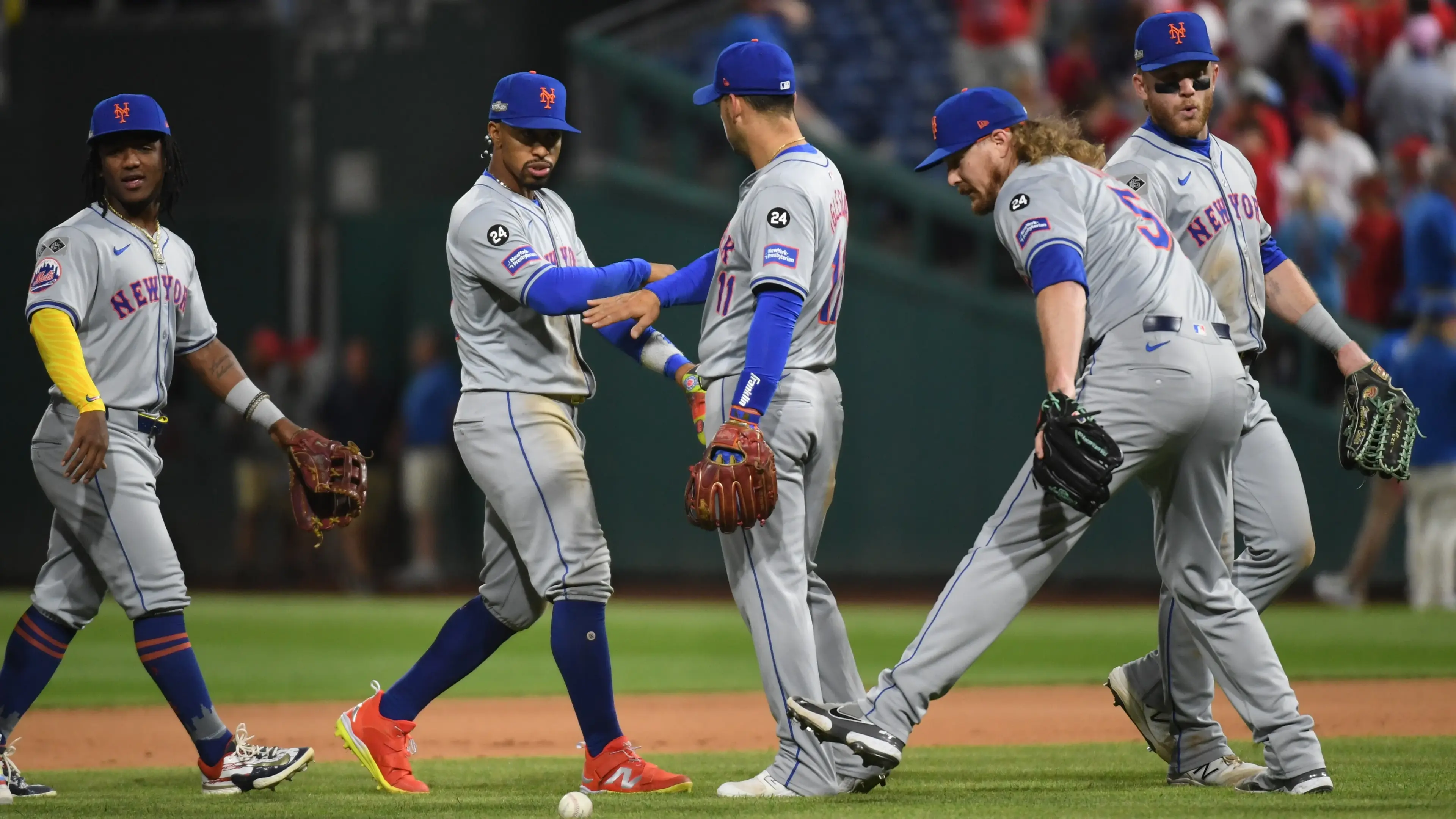 Oct 5, 2024; Philadelphia, PA, USA; New York Mets shortstop Francisco Lindor (12) and New York Mets second baseman Jose Iglesias (11) celebrate after defeating the Philadelphia Phillies in game one of the NLDS for the 2024 MLB Playoffs at Citizens Bank Park. Mandatory Credit: Eric Hartline-Imagn Images / © Eric Hartline-Imagn Images