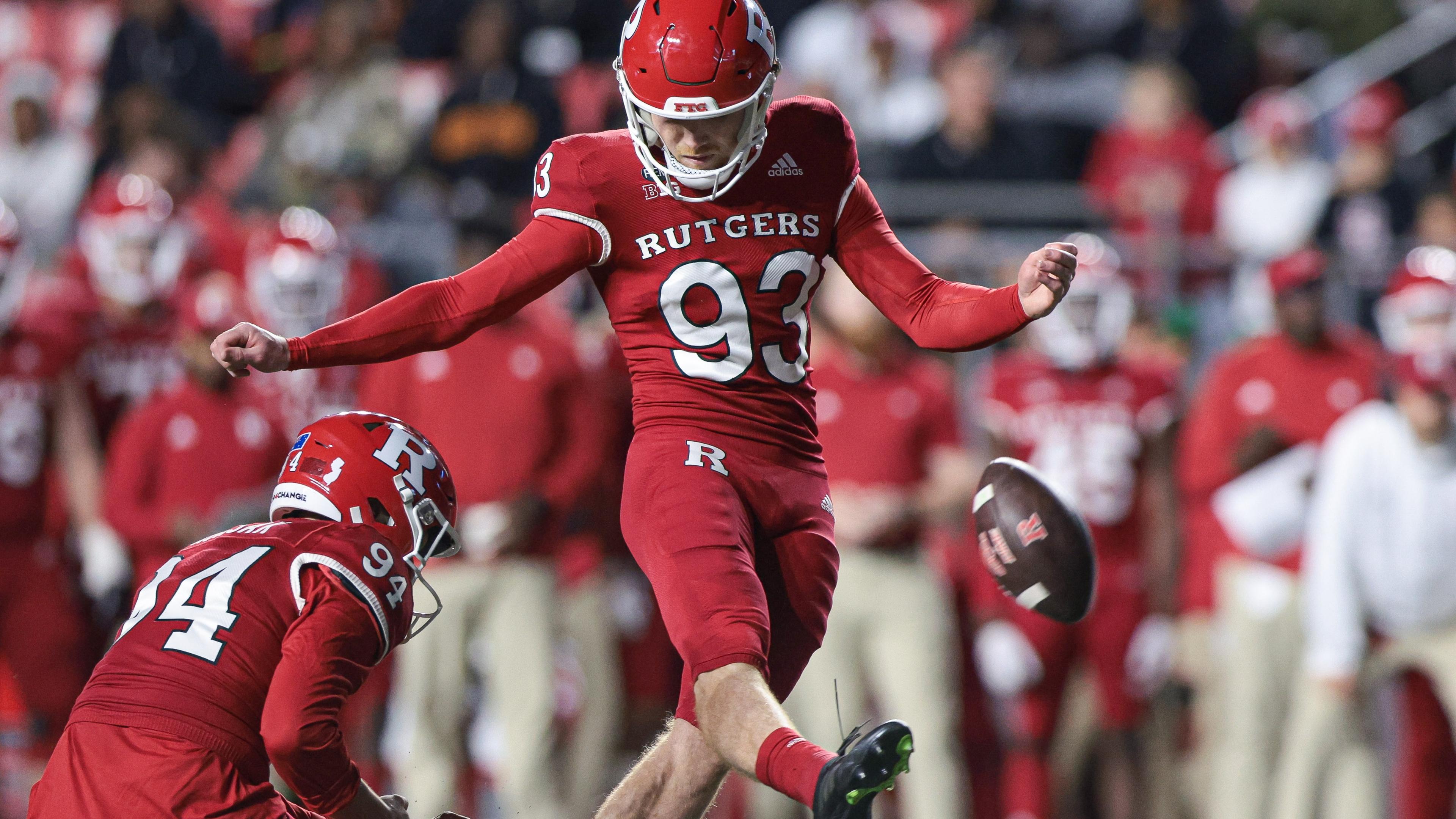 Rutgers Scarlet Knights place kicker Jude McAtamney (93) kicks a field goal as punter Adam Korsak (94) holds during the first half against the Iowa Hawkeyes at SHI Stadium