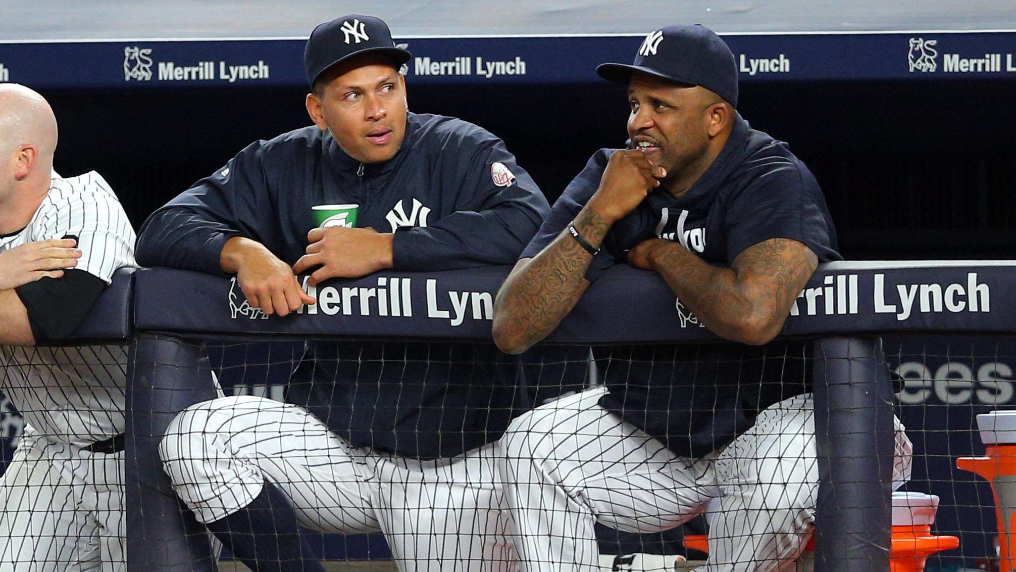 New York Yankees pinch hitter Alex Rodriguez (13) talks with New York Yankees starting pitcher CC Sabathia (52) in the dugout during the ninth inning against the New York Mets at Yankee Stadium.