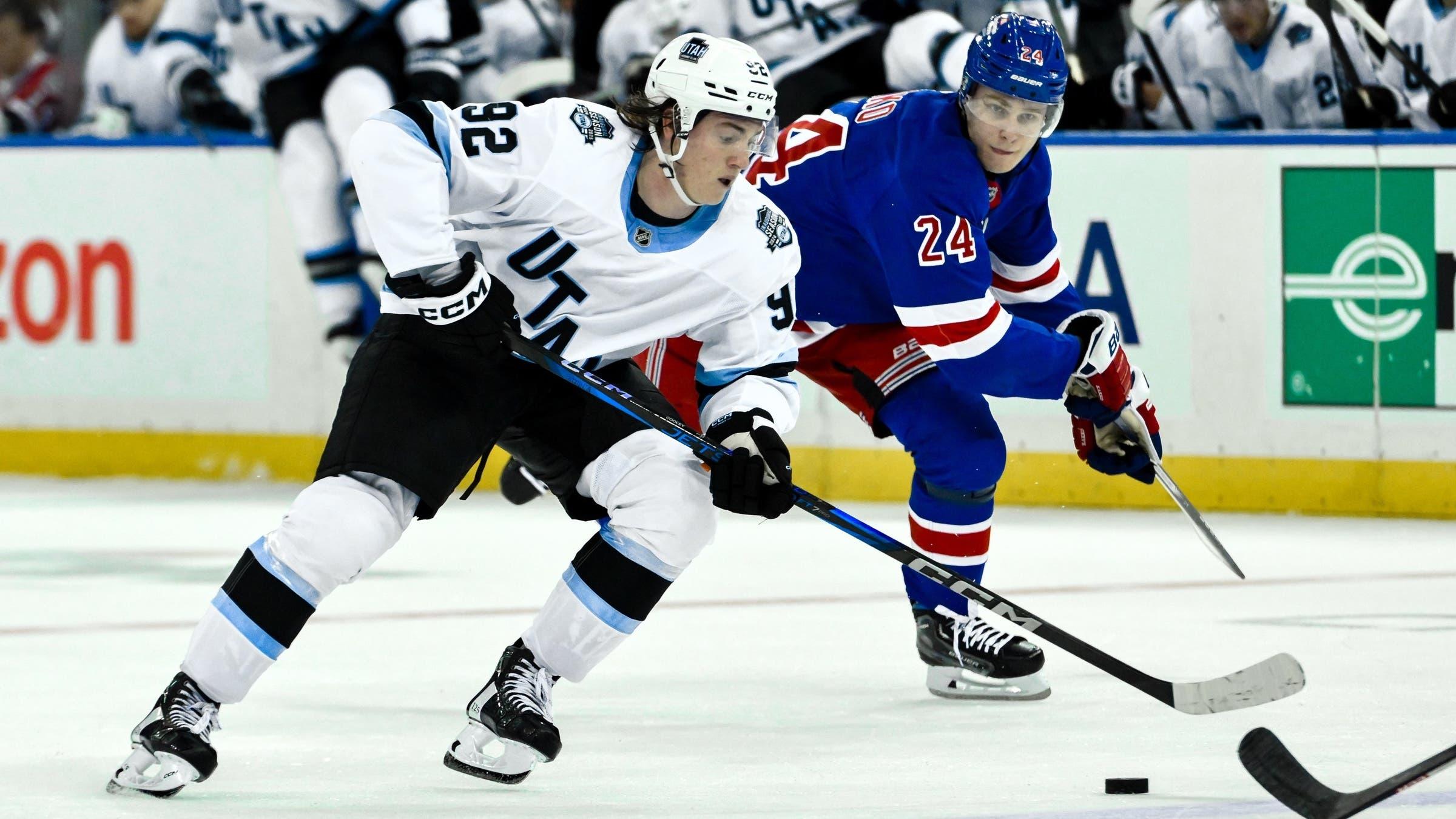 Utah Hockey Club center Logan Cooley (92) skates with the puck against New York Rangers right wing Kaapo Kakko (24) during the third period at Madison Square Garden. / John Jones-Imagn Images