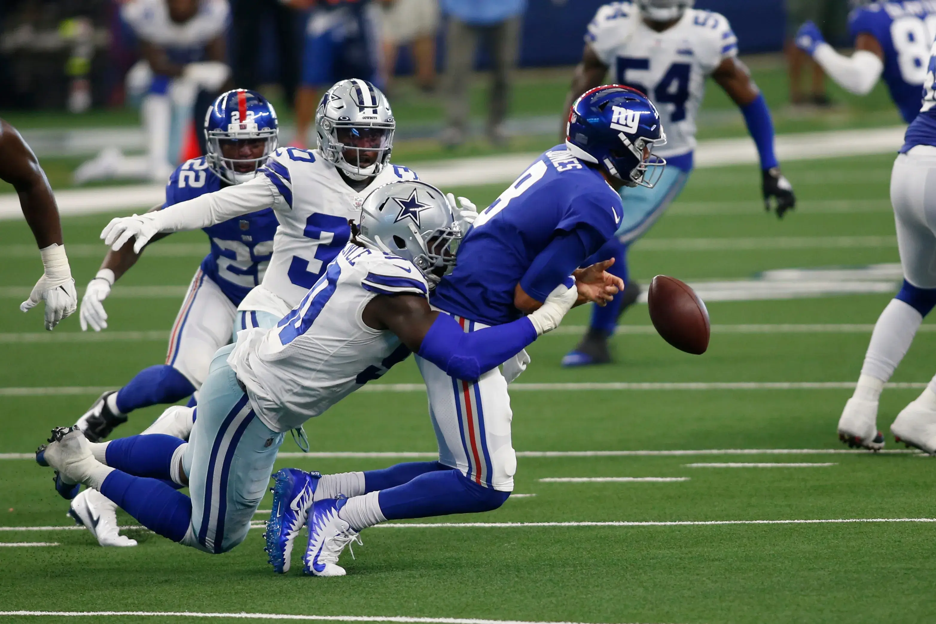 Oct 11, 2020; Arlington, Texas, USA; Dallas Cowboys defensive end DeMarcus Lawrence (90) sacks New York Giants quarterback Daniel Jones (8) in the second quarter at AT&T Stadium / Tim Heitman-USA TODAY Sports