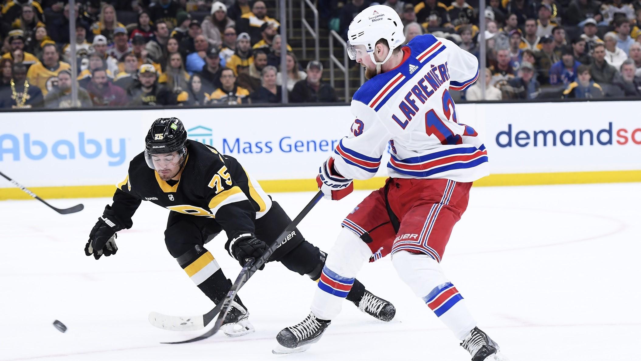 Mar 4, 2023; Boston, Massachusetts, USA; New York Rangers left wing Alexis Lafreniere (13) shoots the puck while Boston Bruins defenseman Connor Clifton (75) defends during the second period at TD Garden.