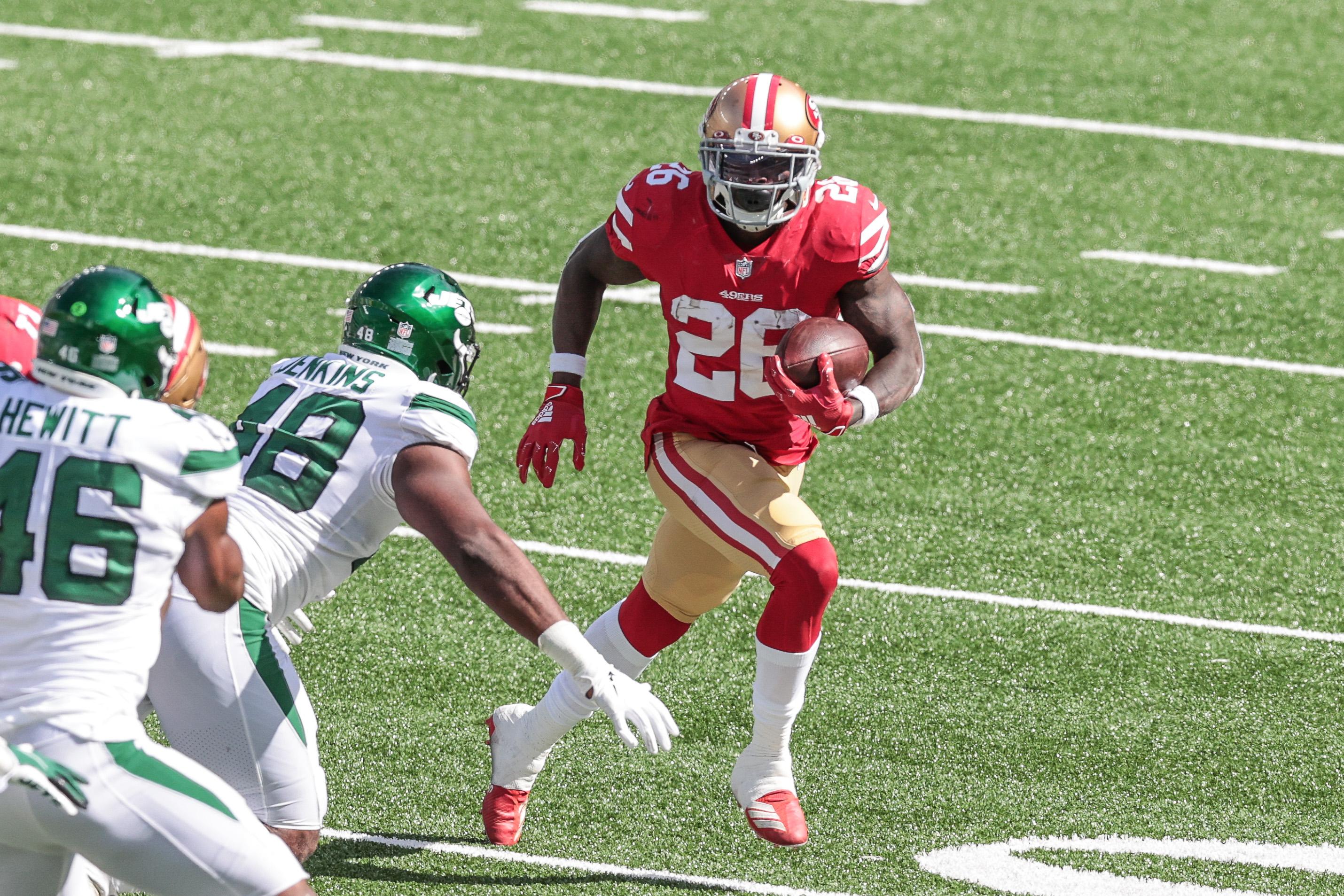 Sep 20, 2020; East Rutherford, New Jersey, USA; San Francisco 49ers running back Tevin Coleman (26) carries the ball as New York Jets outside linebacker Jordan Jenkins (48) defends during the second half at MetLife Stadium. Mandatory Credit: Vincent Carchietta-USA TODAY Sports