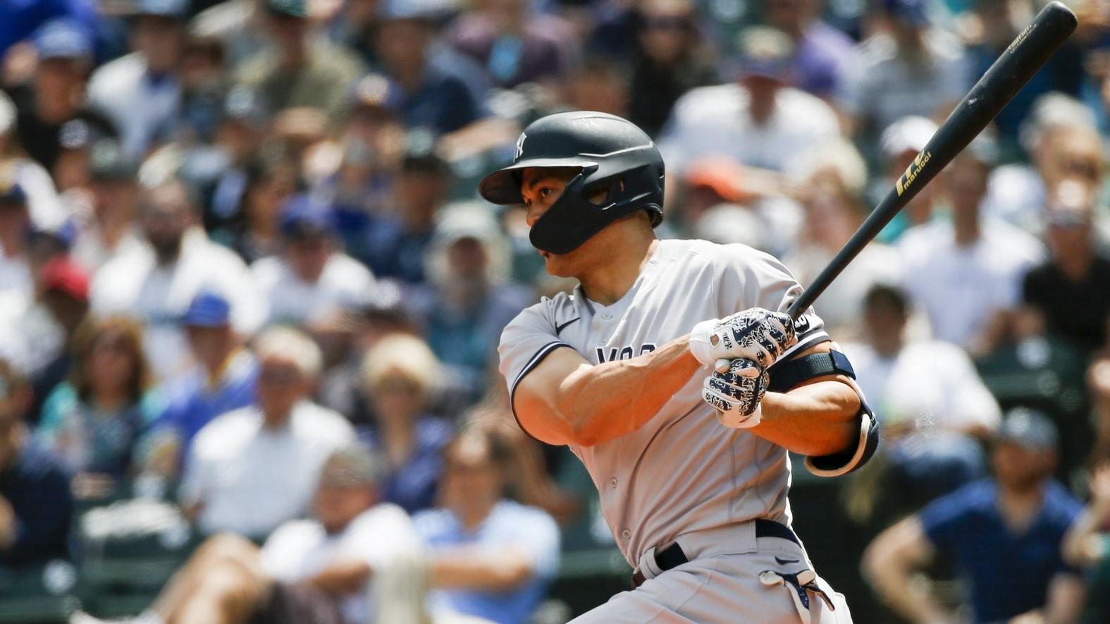 Jul 8, 2021; Seattle, Washington, USA; New York Yankees designated hitter Giancarlo Stanton (27) hits a single against the Seattle Mariners during the second inning at T-Mobile Park.