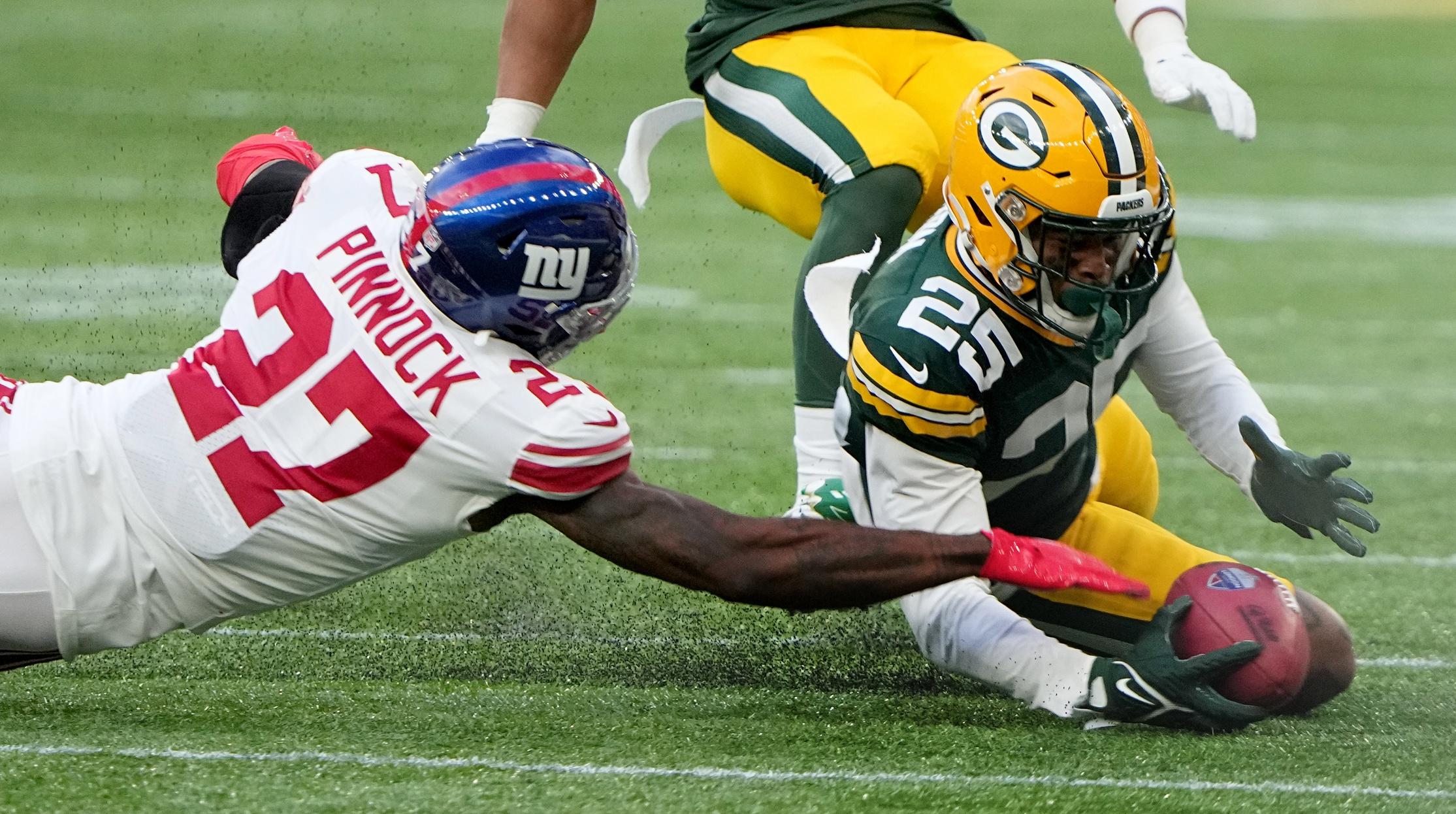 Green Bay Packers cornerback Keisean Nixon (25) is unable to beat New York Giants cornerback Jason Pinnock (27) to a muffed punt during the fourth quarter at Tottenham Hotspur Stadium. The New York Giants beat the Green Bay Packers 27-22.