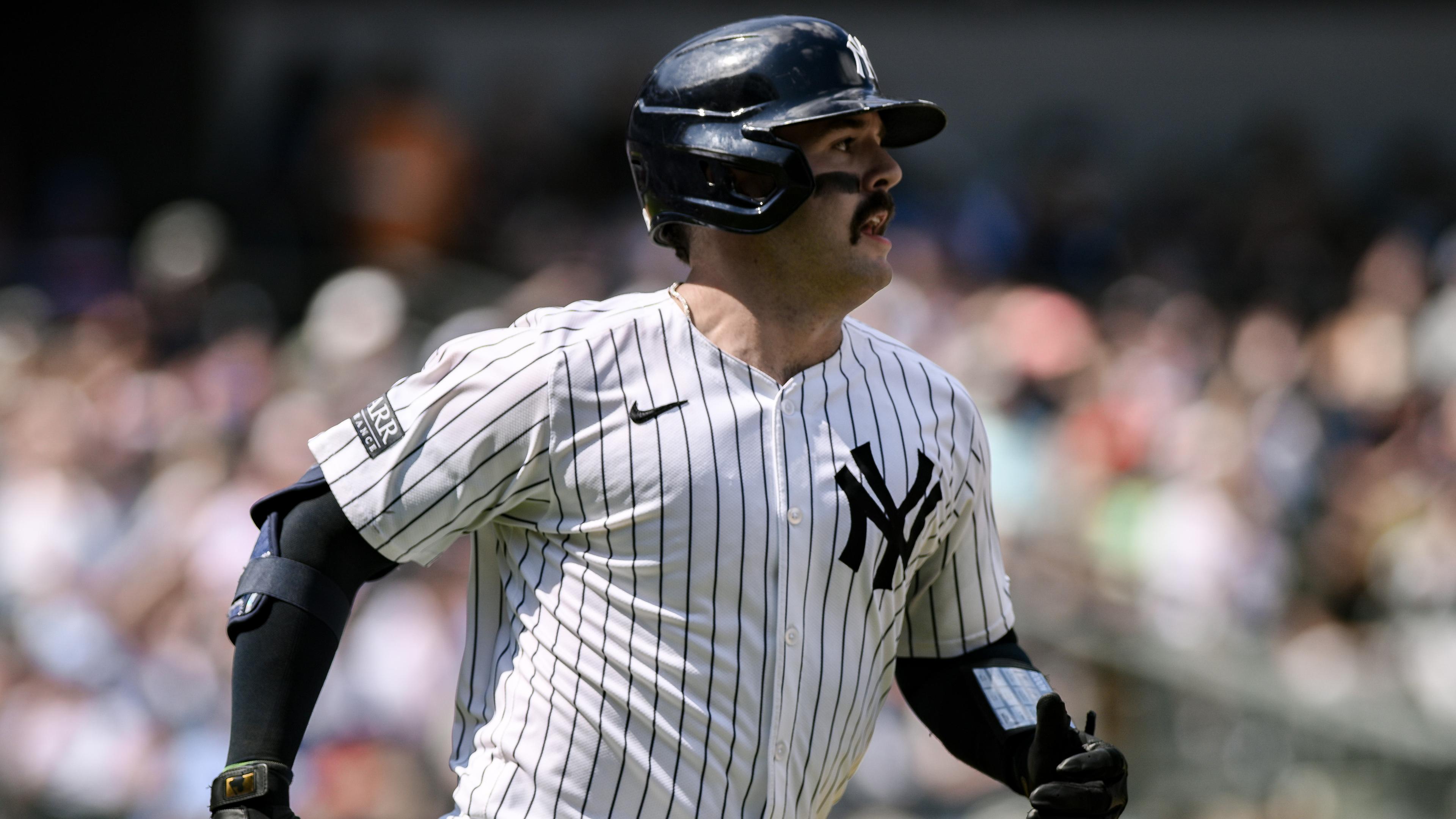 New York Yankees catcher Austin Wells (28) hits a two RBI single against the Texas Rangers during the fourth inning at Yankee Stadium