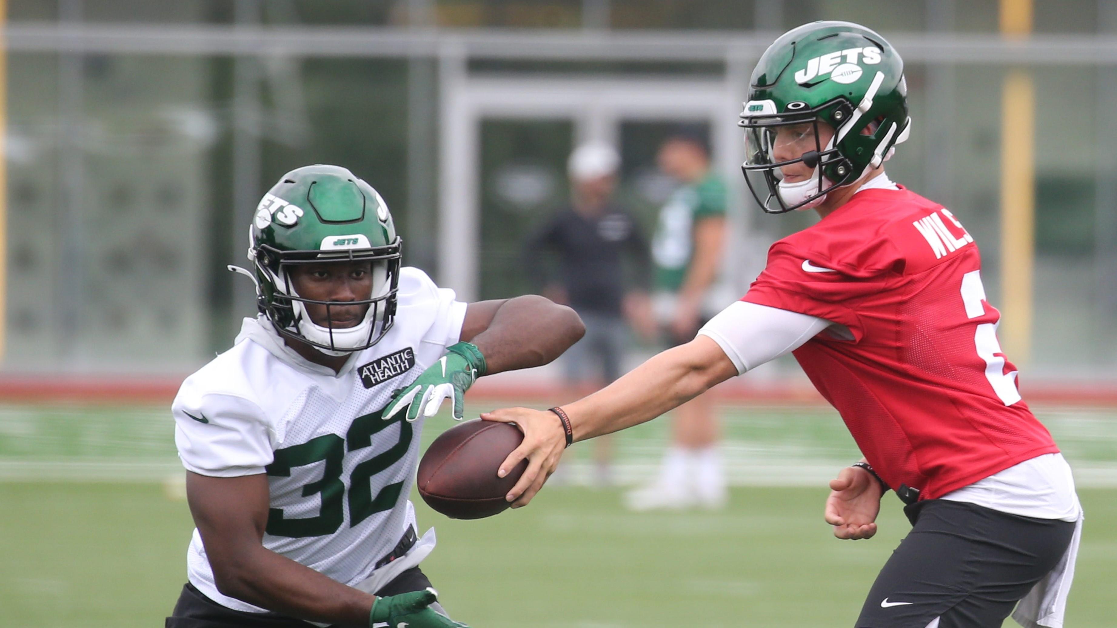 Quarterback, Zach Wilson hands the ball off to Michael Carter while participating in practice as the New York Jets held OTA's this morning at their practice facility in Florham Park, NJ on June 4, 2021. The New York Jets Held Ota S This Morning At Their Practice Facility In Florham Park Nj On June 4 2021