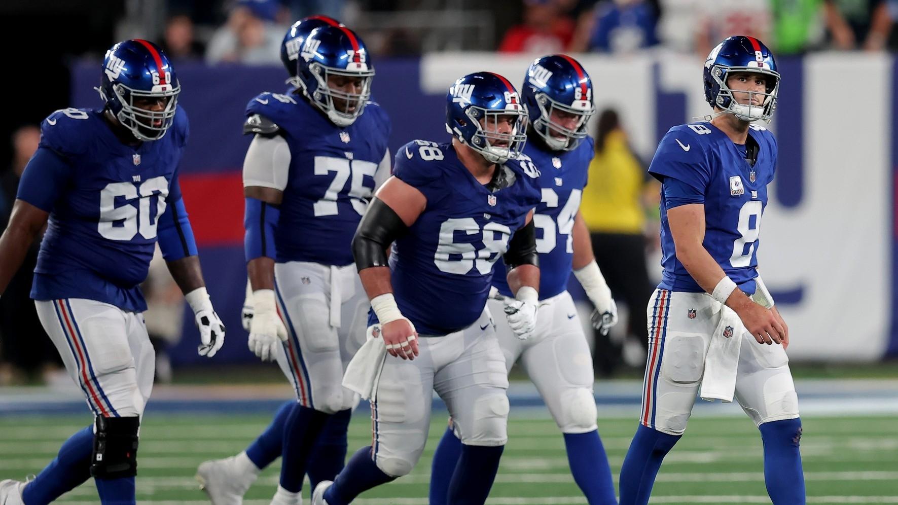 Giants quarterback Daniel Jones (8) walks off the field with guards Marcus McKethan (60) and Joshua Ezeudu (75) and Ben Bredeson (68) and Mark Glowinski (64) after being sacked during the fourth quarter against the Seattle Seahawks.