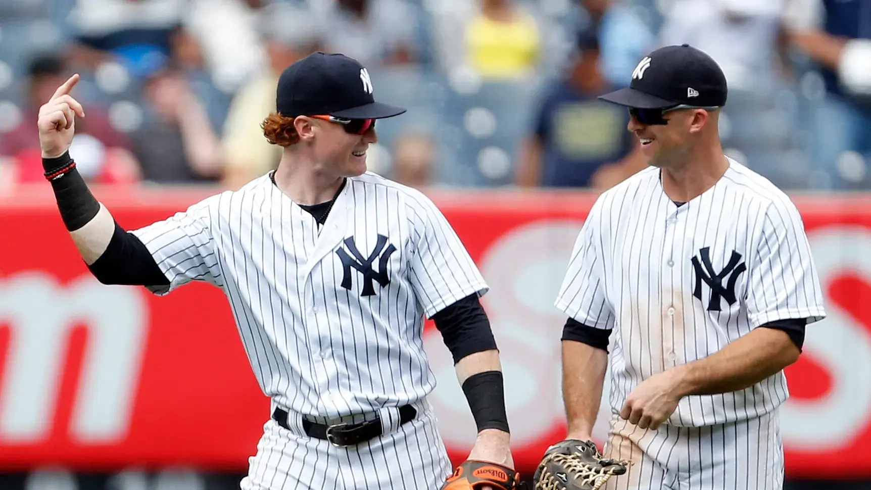 New York Yankees right fielder Clint Frazier (77) and New York Yankees left fielder Brett Gardner (11) celebrate their win over the Cincinnati Reds at Yankee Stadium. / Adam Hunger-USA TODAY Sports