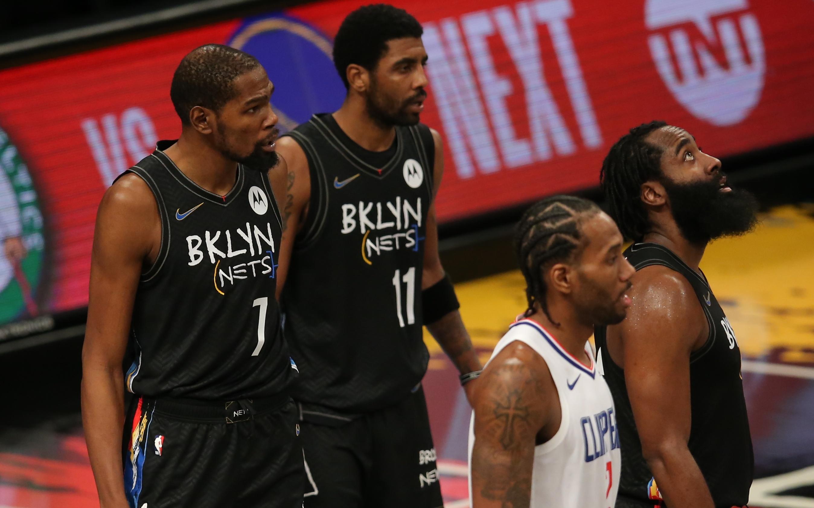 Feb 2, 2021; Brooklyn, New York, USA; Brooklyn Nets power forward Kevin Durant (7) and point guard Kyrie Irving (11) and shooting guard James Harden (13) and Los Angeles Clippers small forward Kawhi Leonard (2) await a replay review during the fourth quarter at Barclays Center. Mandatory Credit: Brad Penner-USA TODAY Sports