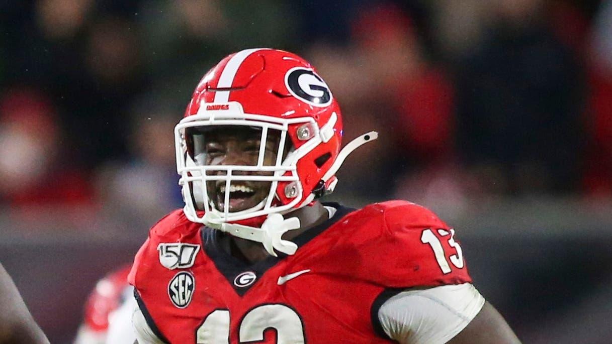 Georgia Bulldogs defensive lineman Jordan Davis (99) and linebacker Azeez Ojulari (13) celebrate after a stop against the Texas A&M Aggies in the third quarter at Sanford Stadium. / Brett Davis-USA TODAY Sports